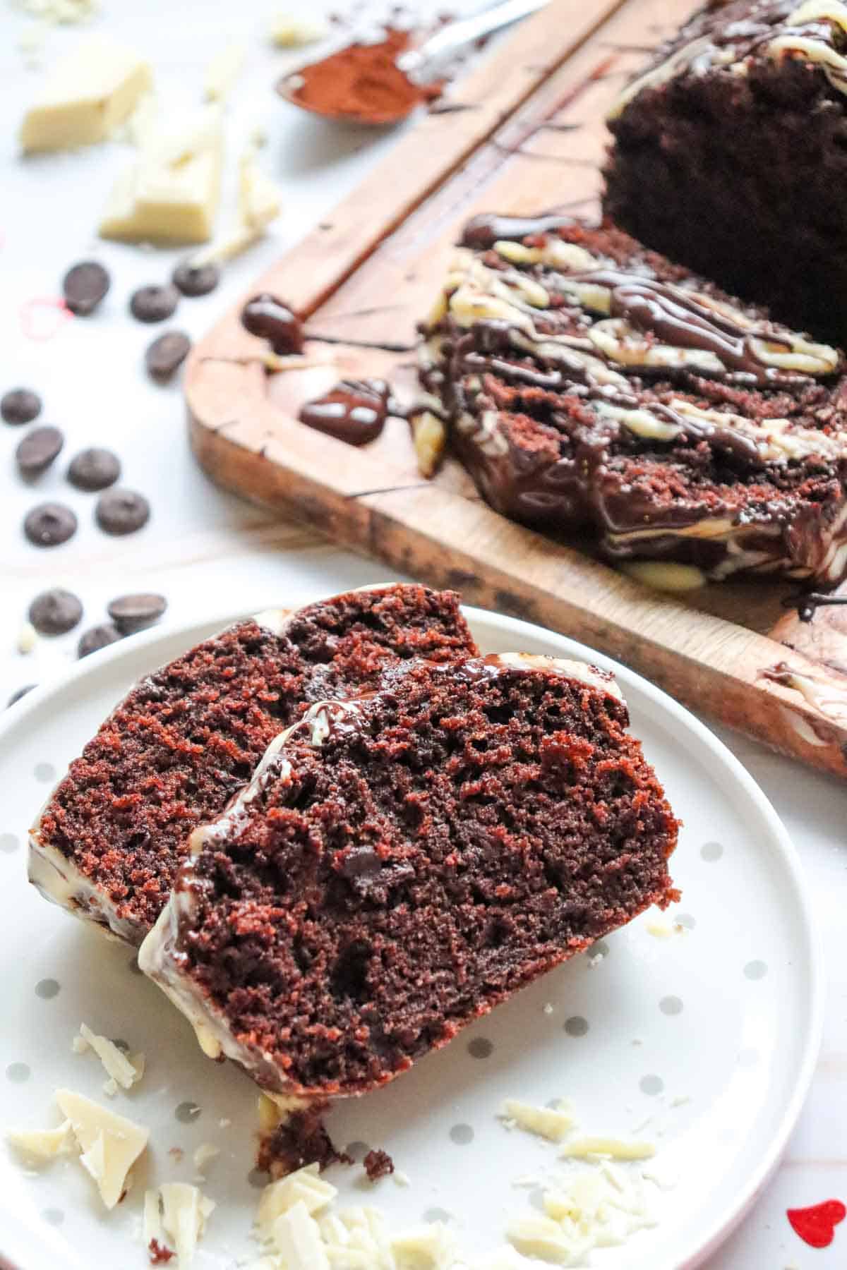 This Chocolate Loaf Cake is a rich, moist and decadent dessert that's perfect for chocolate lovers! This easy Chocolate Loaf Cake Recipe is made with cocoa powder, buttermilk and dark chocolate chips for a soft, tender crumb packed with chocolate flavor. Topped with a dark chocolate and white chocolate drizzle, this homemade chocolate bread makes an impressive but simple dessert for any occasion. If you're looking for Easy Loaf Cake Recipes, Chocolate Dessert Recipes, Chocolate Bread Recipes, Easy Baking Recipes or a Moist Chocolate Cake Recipe, this one belongs on your baking list. Serve this Chocolate Chip Loaf Cake for birthdays, holidays, afternoon treats, brunch or dessert. It's an easy chocolate cake that's delicious with coffee, tea or a glass of milk and perfect for sharing!
