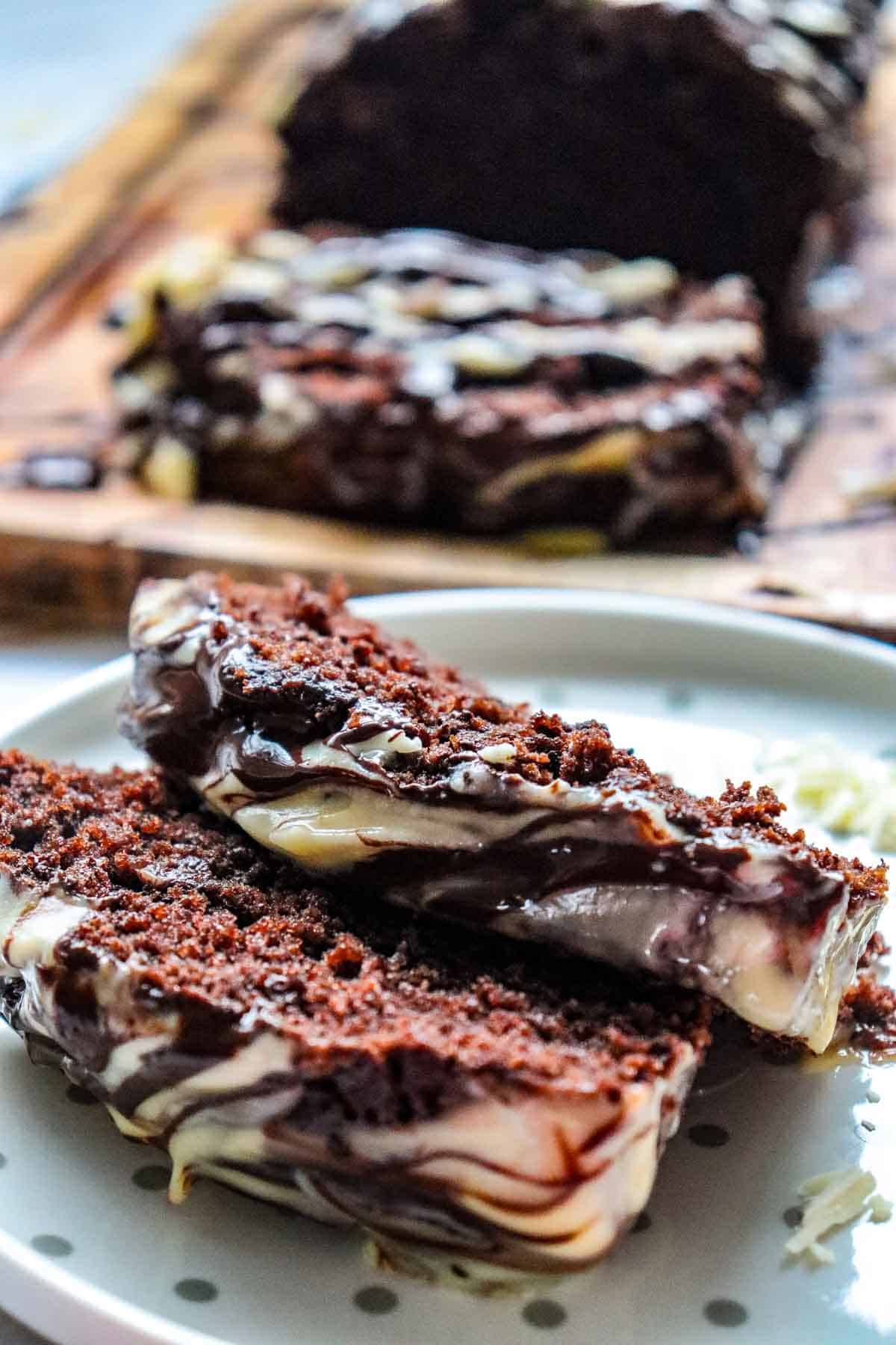 This Chocolate Loaf Cake is a rich, moist and decadent dessert that's perfect for chocolate lovers! This easy Chocolate Loaf Cake Recipe is made with cocoa powder, buttermilk and dark chocolate chips for a soft, tender crumb packed with chocolate flavor. Topped with a dark chocolate and white chocolate drizzle, this homemade chocolate bread makes an impressive but simple dessert for any occasion. If you're looking for Easy Loaf Cake Recipes, Chocolate Dessert Recipes, Chocolate Bread Recipes, Easy Baking Recipes or a Moist Chocolate Cake Recipe, this one belongs on your baking list. Serve this Chocolate Chip Loaf Cake for birthdays, holidays, afternoon treats, brunch or dessert. It's an easy chocolate cake that's delicious with coffee, tea or a glass of milk and perfect for sharing!