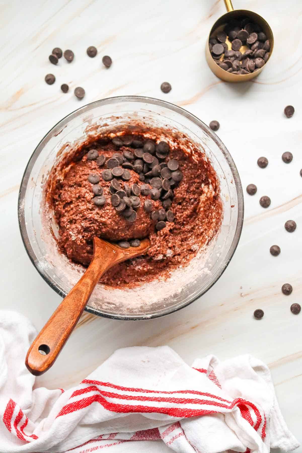chocolate chips added to bowl with chocolate loaf cake batter