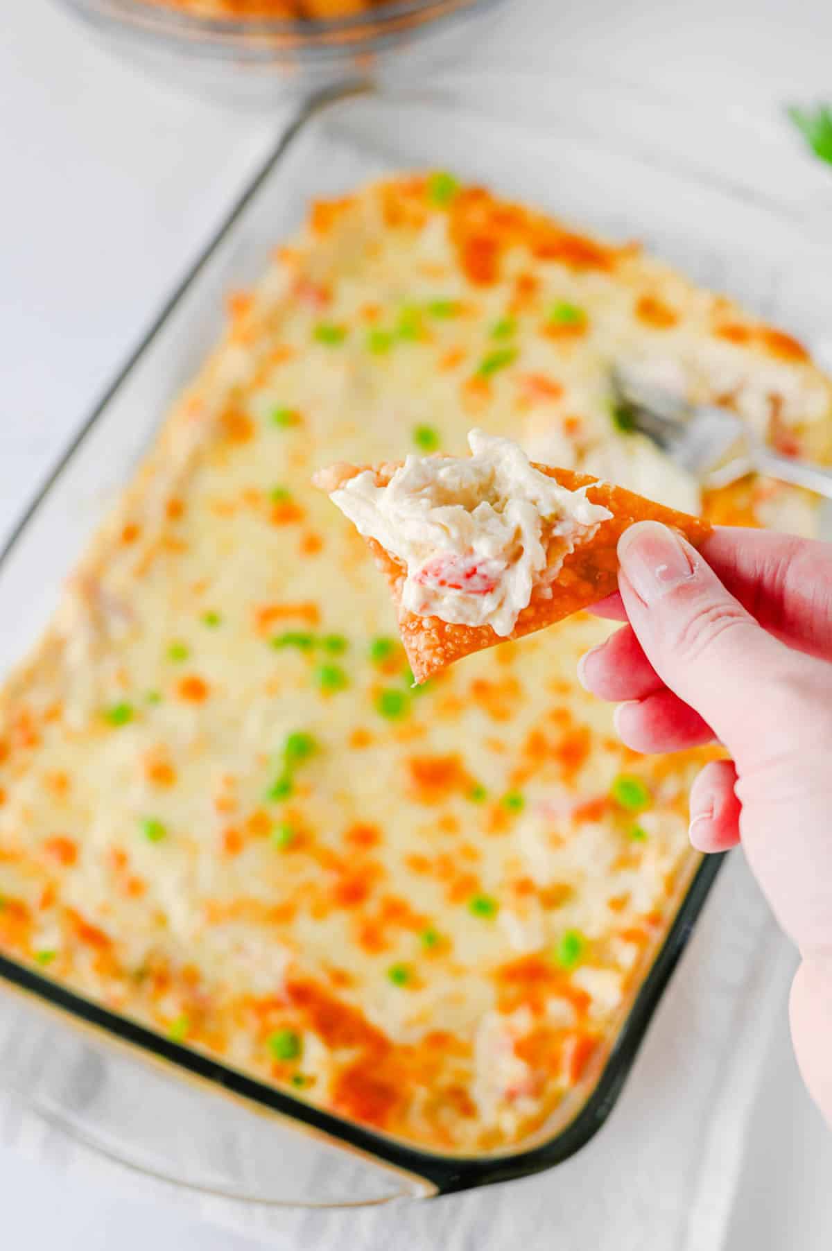 scoop of crab dip on a fried wonton wrapper