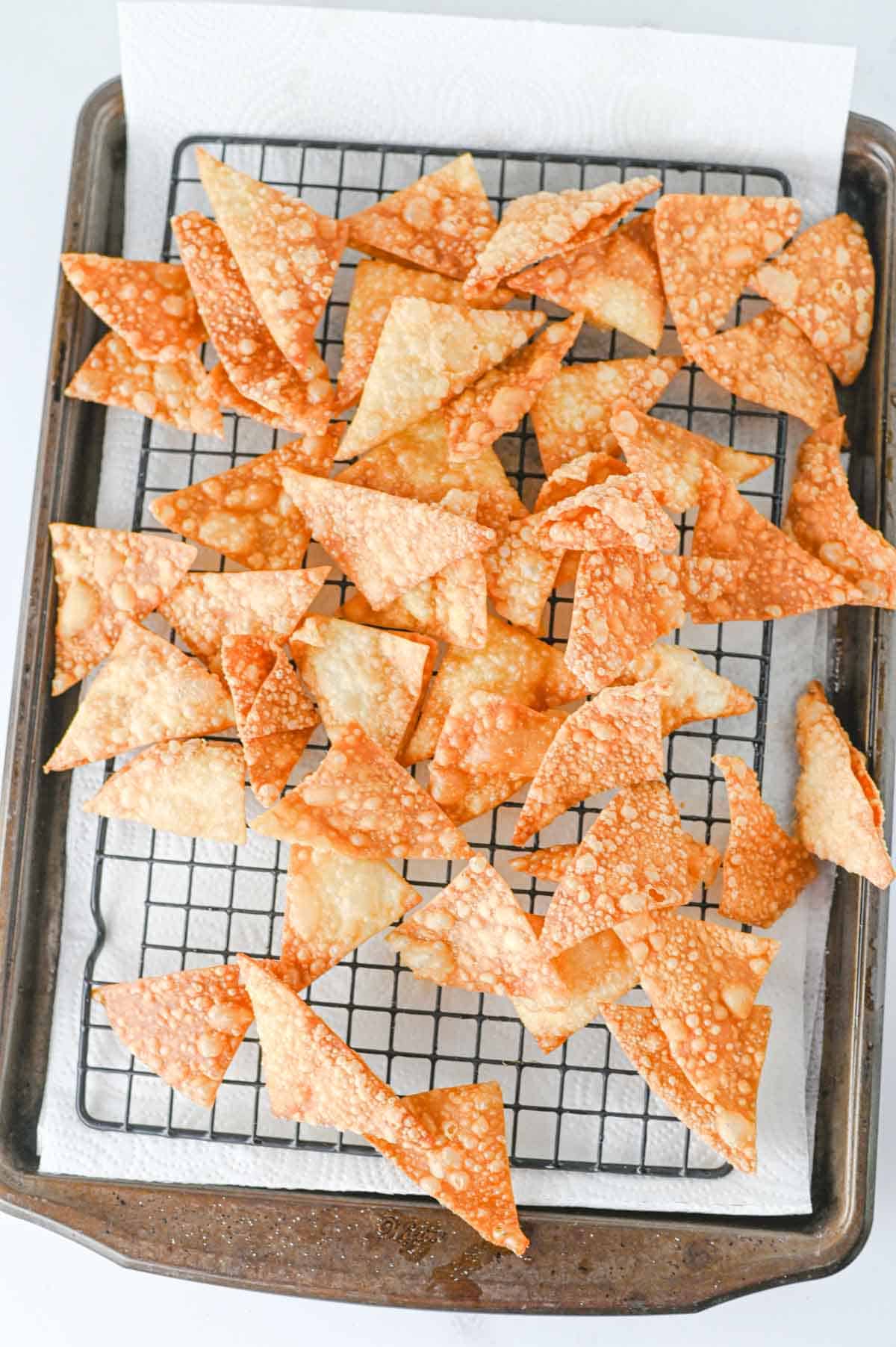 fried wonton wrappers on a cooling rack