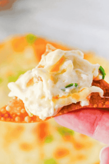 This Crab Rangoon Dip is the ultimate hot party appetizer for anyone who loves creamy crab rangoon, crispy wontons and easy baked dip recipes. Made with cream cheese, sour cream, mayonnaise, imitation crab meat, soy sauce, garlic, Monterey Jack cheese and green onions, this cheesy crab dip bakes until warm, bubbly and perfect for scooping. Serve it with homemade fried wonton chips for a fun game day snack, holiday appetizer, potluck dip or New Year’s Eve party food. This easy crab rangoon dip recipe has all the flavour of the classic takeout appetizer without stuffing or folding wontons. Save this hot crab dip for your next party appetizer spread, football food table, Christmas appetizer tray or easy entertaining menu.