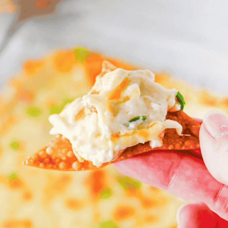 This Crab Rangoon Dip is the ultimate hot party appetizer for anyone who loves creamy crab rangoon, crispy wontons and easy baked dip recipes. Made with cream cheese, sour cream, mayonnaise, imitation crab meat, soy sauce, garlic, Monterey Jack cheese and green onions, this cheesy crab dip bakes until warm, bubbly and perfect for scooping. Serve it with homemade fried wonton chips for a fun game day snack, holiday appetizer, potluck dip or New Year’s Eve party food. This easy crab rangoon dip recipe has all the flavour of the classic takeout appetizer without stuffing or folding wontons. Save this hot crab dip for your next party appetizer spread, football food table, Christmas appetizer tray or easy entertaining menu.