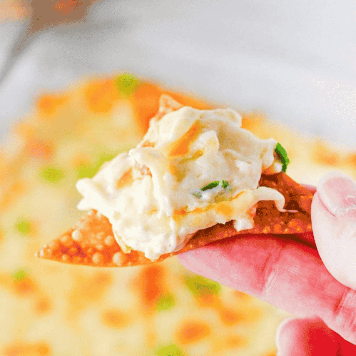 This Crab Rangoon Dip is the ultimate hot party appetizer for anyone who loves creamy crab rangoon, crispy wontons and easy baked dip recipes. Made with cream cheese, sour cream, mayonnaise, imitation crab meat, soy sauce, garlic, Monterey Jack cheese and green onions, this cheesy crab dip bakes until warm, bubbly and perfect for scooping. Serve it with homemade fried wonton chips for a fun game day snack, holiday appetizer, potluck dip or New Year’s Eve party food. This easy crab rangoon dip recipe has all the flavour of the classic takeout appetizer without stuffing or folding wontons. Save this hot crab dip for your next party appetizer spread, football food table, Christmas appetizer tray or easy entertaining menu.