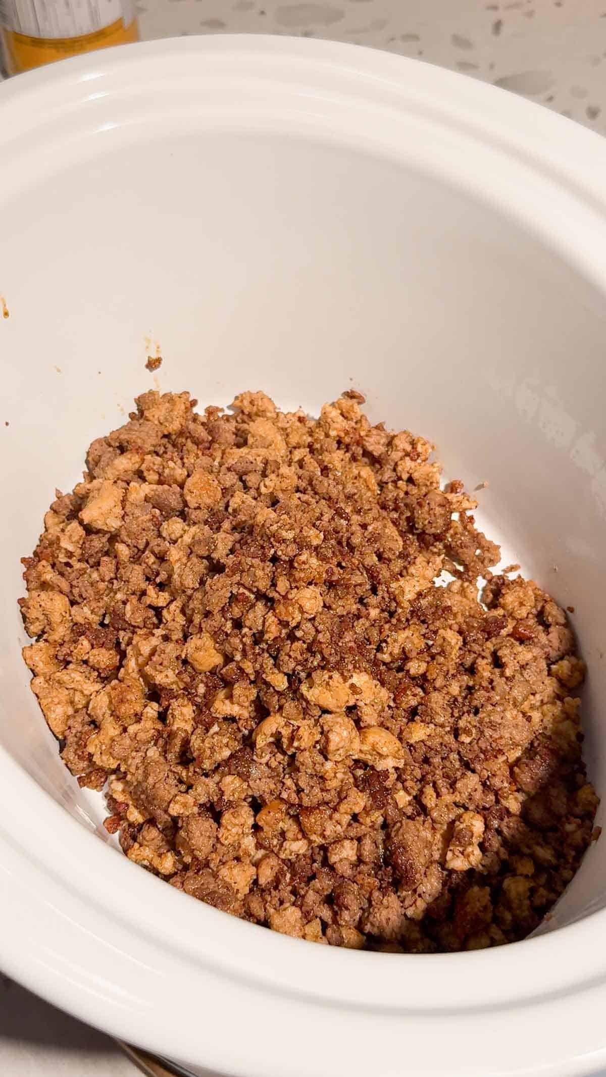 cooked ground meat mixture in a crock pot