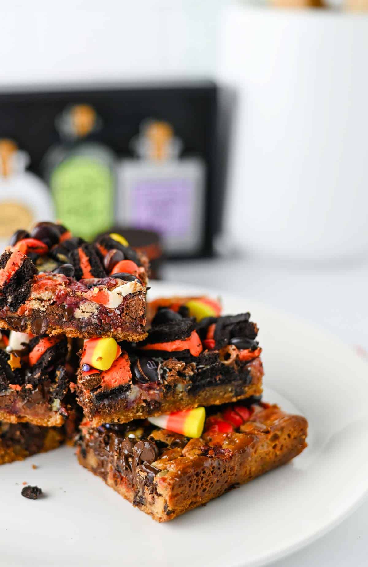 These Halloween Layer Bars are an easy Halloween dessert, loaded with chocolate chip cookie dough, Halloween Oreos, M&Ms, Reese’s Pieces, candy corn and festive sprinkles. If you’re looking for Halloween desserts for a party, Halloween treats for kids, easy Halloween baking ideas or fun Halloween party food, these gooey cookie bars check every box. A buttery chocolate chip cookie base is piled high with crushed Oreos, chocolate candy and sweetened condensed milk for rich, chewy layers in every bite. These Halloween cookie bars are perfect for a Halloween bake sale, classroom party, spooky movie night or October dessert table. Save this Halloween layer bars recipe when you need easy Halloween treats, candy corn desserts, Halloween Oreo desserts or a fun way to use Halloween candy!