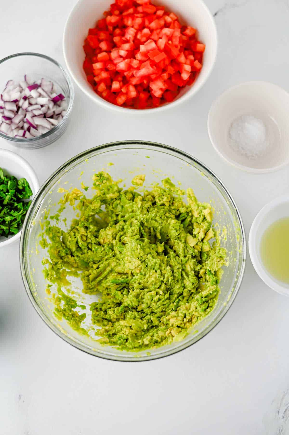 mashed avocados in a mixing bowl