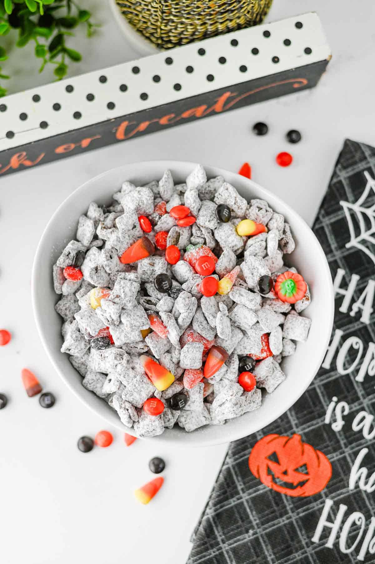 Halloween Muddy Buddies are easy Halloween snack for parties and spooky season snacking! This Halloween Muddy Buddies Recipe combines crunchy Rice Chex cereal with melted chocolate, creamy peanut butter, butter, and powdered sugar for classic Puppy Chow, then adds Halloween M&Ms and candy corn for a festive twist. If you need Easy Halloween Treats, Halloween Party Food, Halloween Snacks For Kids, or a No Bake Halloween Dessert, this sweet and crunchy snack mix takes just 15 minutes of prep. Serve it at a Halloween Party, Halloween Sleepover, classroom celebration, fall gathering, or Halloween movie night. This Halloween Chex Mix is colorful, crowd-pleasing, and perfect for anyone searching for Halloween Puppy Chow, Muddy Buddies Chex Mix, Halloween Snack Mix, or fun Halloween Food Ideas.