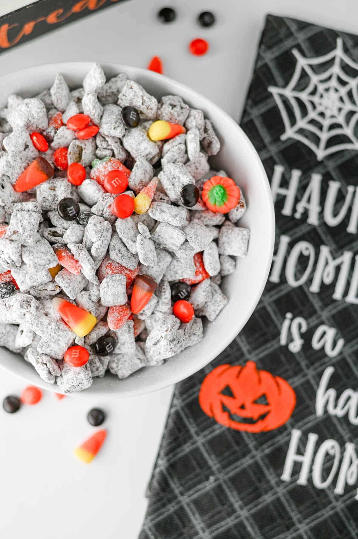 Halloween Muddy Buddies are easy Halloween snack for parties and spooky season snacking! This Halloween Muddy Buddies Recipe combines crunchy Rice Chex cereal with melted chocolate, creamy peanut butter, butter, and powdered sugar for classic Puppy Chow, then adds Halloween M&Ms and candy corn for a festive twist. If you need Easy Halloween Treats, Halloween Party Food, Halloween Snacks For Kids, or a No Bake Halloween Dessert, this sweet and crunchy snack mix takes just 15 minutes of prep. Serve it at a Halloween Party, Halloween Sleepover, classroom celebration, fall gathering, or Halloween movie night. This Halloween Chex Mix is colorful, crowd-pleasing, and perfect for anyone searching for Halloween Puppy Chow, Muddy Buddies Chex Mix, Halloween Snack Mix, or fun Halloween Food Ideas.