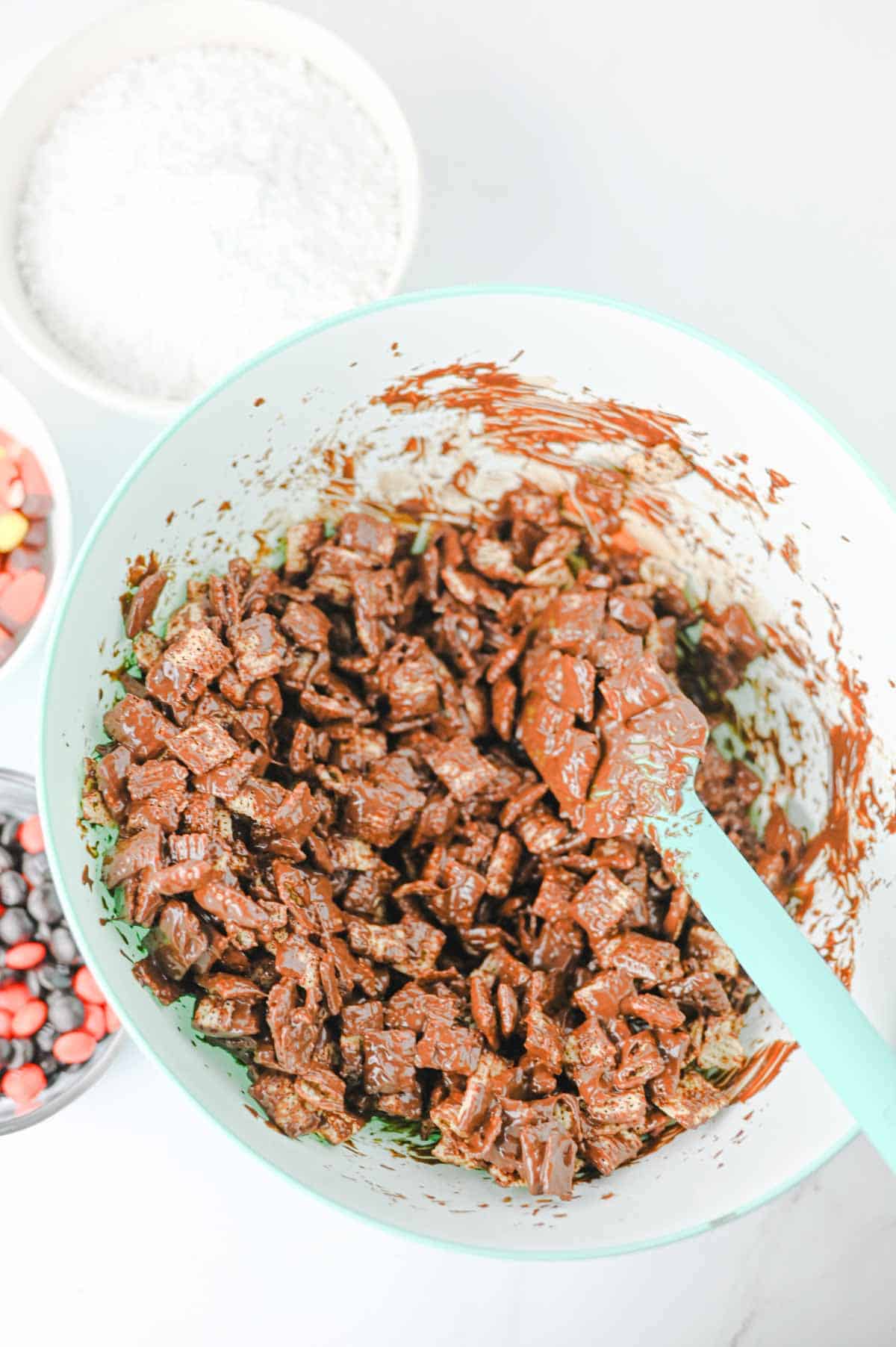 chex cereal being stirred in chocolate and peanut butter mixture