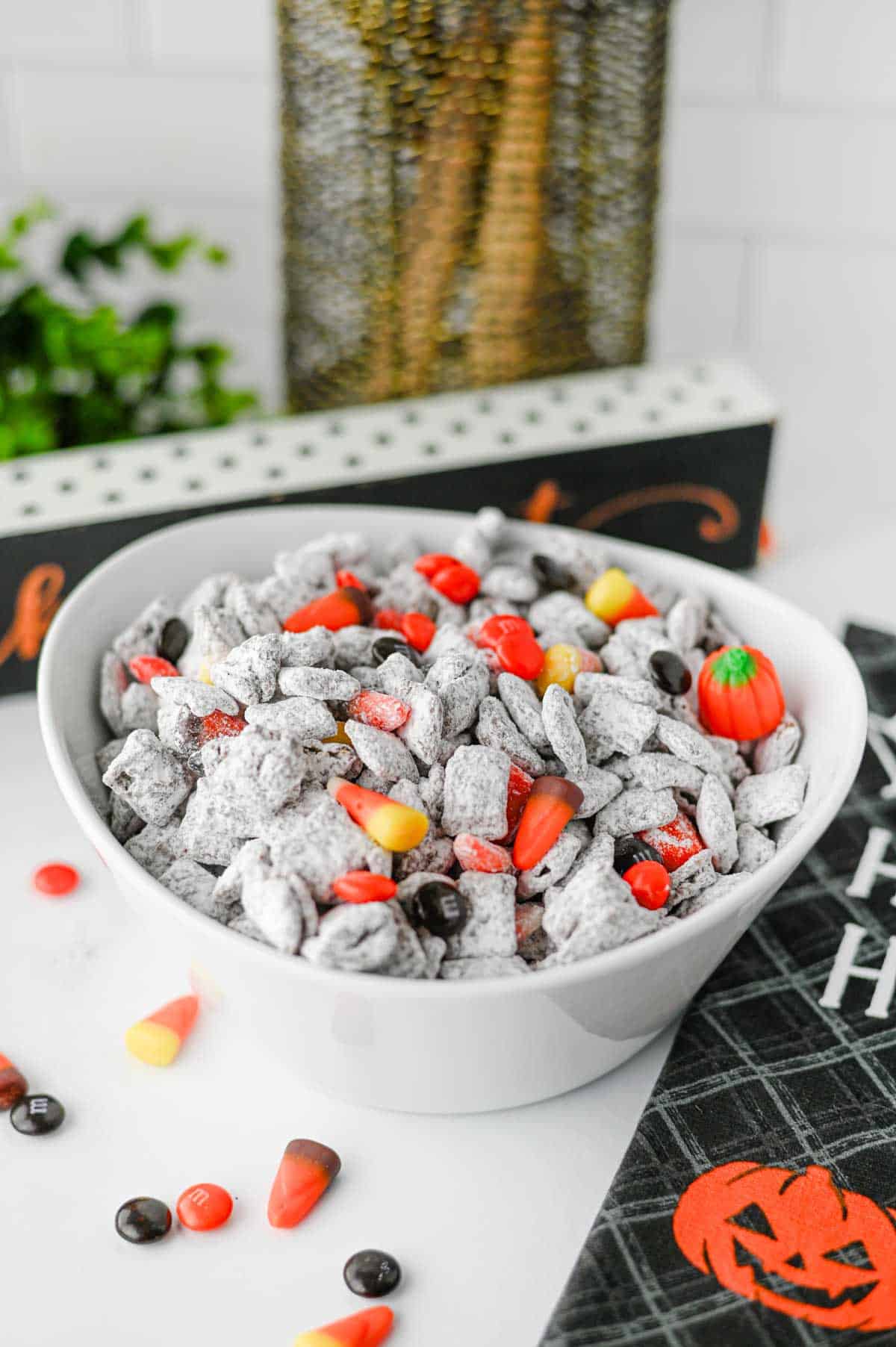 Halloween Muddy Buddies are easy Halloween snack for parties and spooky season snacking! This Halloween Muddy Buddies Recipe combines crunchy Rice Chex cereal with melted chocolate, creamy peanut butter, butter, and powdered sugar for classic Puppy Chow, then adds Halloween M&Ms and candy corn for a festive twist. If you need Easy Halloween Treats, Halloween Party Food, Halloween Snacks For Kids, or a No Bake Halloween Dessert, this sweet and crunchy snack mix takes just 15 minutes of prep. Serve it at a Halloween Party, Halloween Sleepover, classroom celebration, fall gathering, or Halloween movie night. This Halloween Chex Mix is colorful, crowd-pleasing, and perfect for anyone searching for Halloween Puppy Chow, Muddy Buddies Chex Mix, Halloween Snack Mix, or fun Halloween Food Ideas.