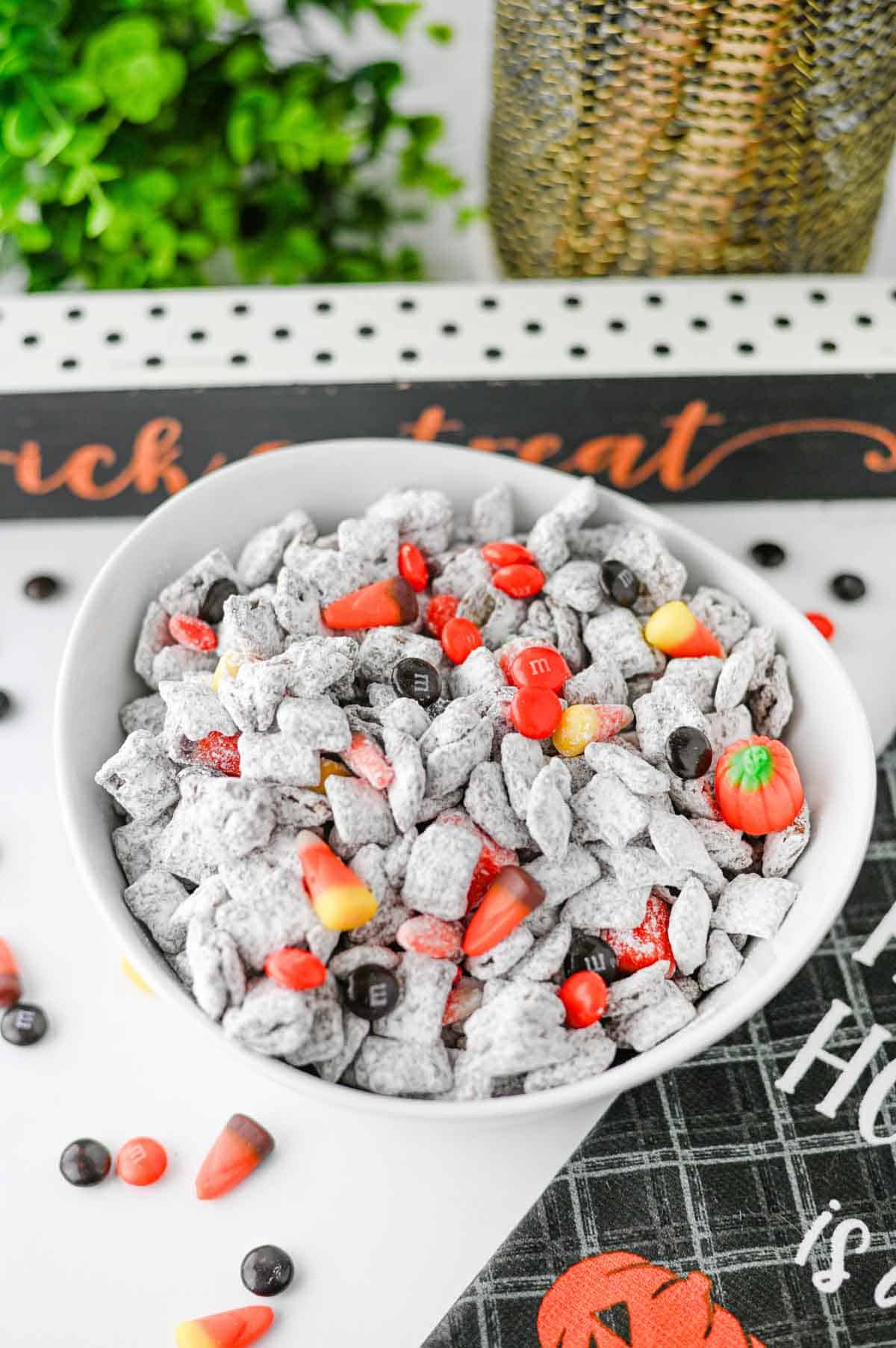 Halloween Muddy Buddies are easy Halloween snack for parties and spooky season snacking! This Halloween Muddy Buddies Recipe combines crunchy Rice Chex cereal with melted chocolate, creamy peanut butter, butter, and powdered sugar for classic Puppy Chow, then adds Halloween M&Ms and candy corn for a festive twist. If you need Easy Halloween Treats, Halloween Party Food, Halloween Snacks For Kids, or a No Bake Halloween Dessert, this sweet and crunchy snack mix takes just 15 minutes of prep. Serve it at a Halloween Party, Halloween Sleepover, classroom celebration, fall gathering, or Halloween movie night. This Halloween Chex Mix is colorful, crowd-pleasing, and perfect for anyone searching for Halloween Puppy Chow, Muddy Buddies Chex Mix, Halloween Snack Mix, or fun Halloween Food Ideas.