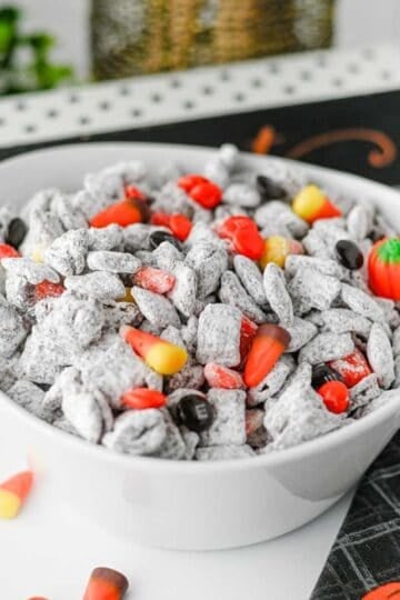 Halloween Muddy Buddies are easy Halloween snack for parties and spooky season snacking! This Halloween Muddy Buddies Recipe combines crunchy Rice Chex cereal with melted chocolate, creamy peanut butter, butter, and powdered sugar for classic Puppy Chow, then adds Halloween M&Ms and candy corn for a festive twist. If you need Easy Halloween Treats, Halloween Party Food, Halloween Snacks For Kids, or a No Bake Halloween Dessert, this sweet and crunchy snack mix takes just 15 minutes of prep. Serve it at a Halloween Party, Halloween Sleepover, classroom celebration, fall gathering, or Halloween movie night. This Halloween Chex Mix is colorful, crowd-pleasing, and perfect for anyone searching for Halloween Puppy Chow, Muddy Buddies Chex Mix, Halloween Snack Mix, or fun Halloween Food Ideas.