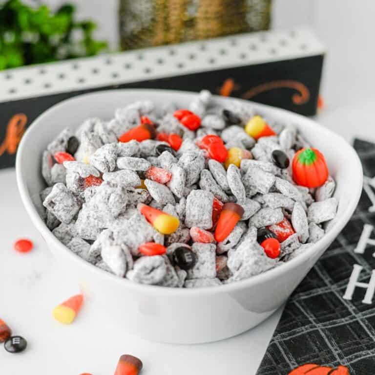 Halloween Muddy Buddies are easy Halloween snack for parties and spooky season snacking! This Halloween Muddy Buddies Recipe combines crunchy Rice Chex cereal with melted chocolate, creamy peanut butter, butter, and powdered sugar for classic Puppy Chow, then adds Halloween M&Ms and candy corn for a festive twist. If you need Easy Halloween Treats, Halloween Party Food, Halloween Snacks For Kids, or a No Bake Halloween Dessert, this sweet and crunchy snack mix takes just 15 minutes of prep. Serve it at a Halloween Party, Halloween Sleepover, classroom celebration, fall gathering, or Halloween movie night. This Halloween Chex Mix is colorful, crowd-pleasing, and perfect for anyone searching for Halloween Puppy Chow, Muddy Buddies Chex Mix, Halloween Snack Mix, or fun Halloween Food Ideas.