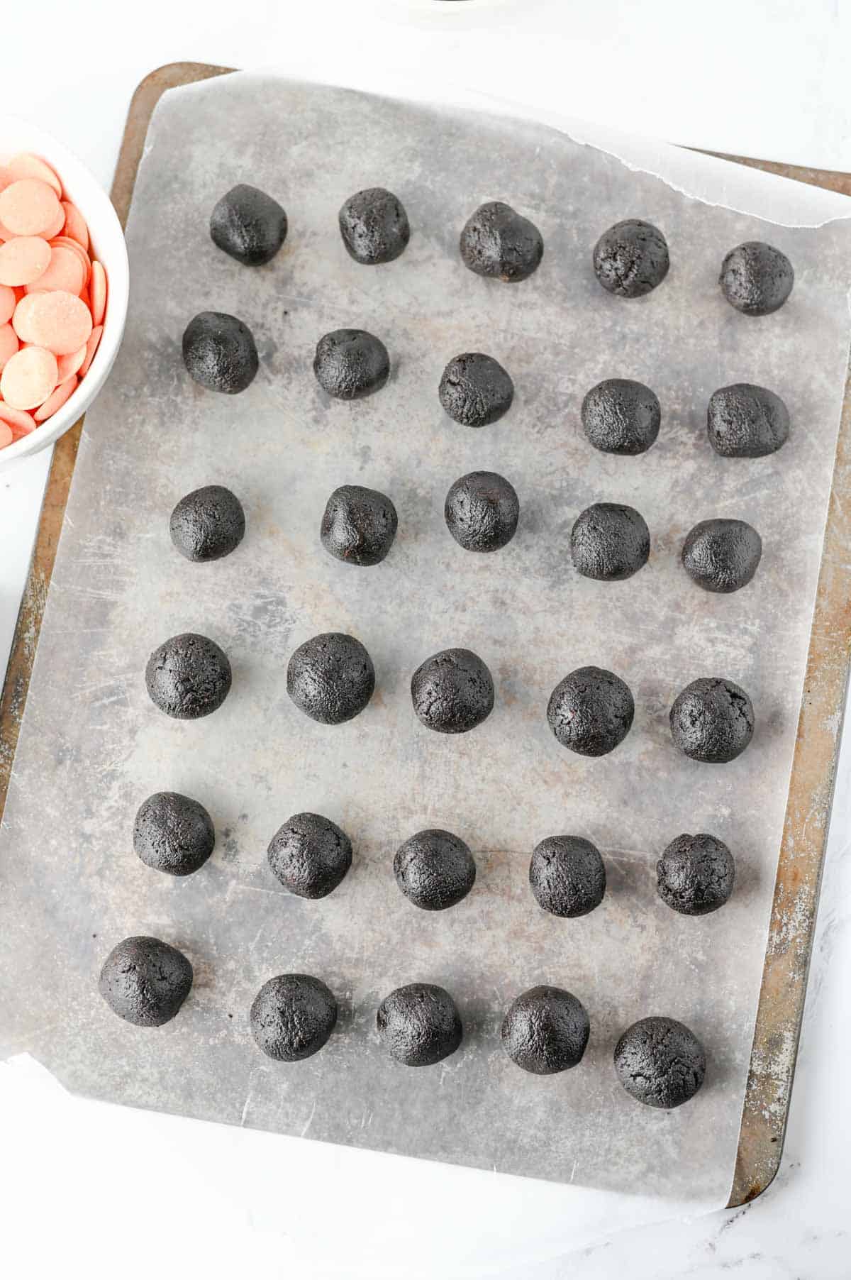 oreo balls on a parchement lined baking sheet