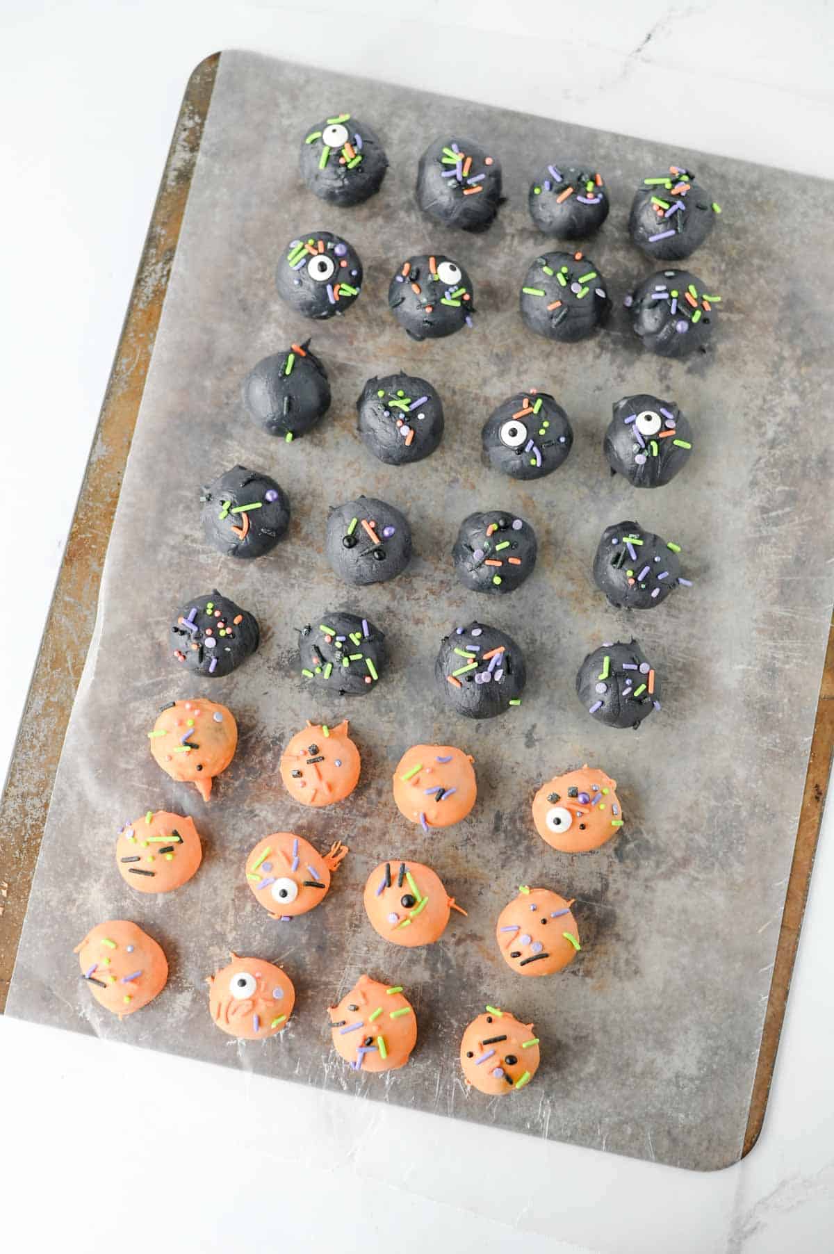 These Halloween Oreo Balls are the ultimate easy no bake Halloween treats for parties and spooky dessert tables! Made with crushed Oreo cookies and cream cheese, these Oreo truffles are dipped in orange and black candy melts and finished with festive Halloween sprinkles. If you're looking for Halloween Oreo balls, Halloween Oreo truffles, easy Halloween desserts, Halloween party food, or fun Halloween treats for kids, this simple recipe is a must-try. They're perfect for Halloween parties, bake sales, potlucks, classroom treats, and movie nights. With just a handful of ingredients and no oven required, these chocolate Oreo balls are an easy Halloween candy treat you can make ahead. Save this Halloween Oreo balls recipe for a spooky and delicious Halloween dessert everyone will love!