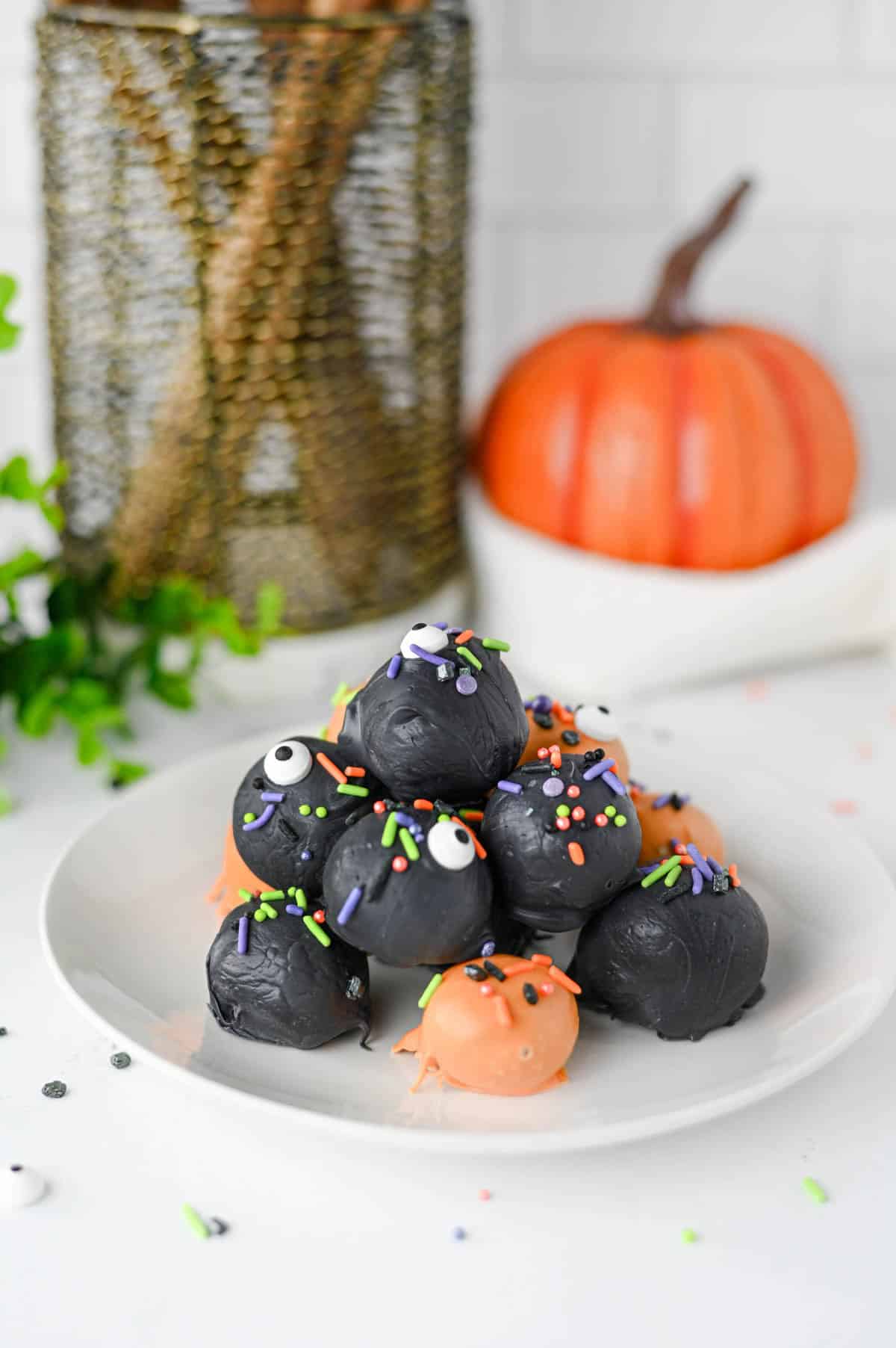These Halloween Oreo Balls are the ultimate easy no bake Halloween treats for parties and spooky dessert tables! Made with crushed Oreo cookies and cream cheese, these Oreo truffles are dipped in orange and black candy melts and finished with festive Halloween sprinkles. If you're looking for Halloween Oreo balls, Halloween Oreo truffles, easy Halloween desserts, Halloween party food, or fun Halloween treats for kids, this simple recipe is a must-try. They're perfect for Halloween parties, bake sales, potlucks, classroom treats, and movie nights. With just a handful of ingredients and no oven required, these chocolate Oreo balls are an easy Halloween candy treat you can make ahead. Save this Halloween Oreo balls recipe for a spooky and delicious Halloween dessert everyone will love!