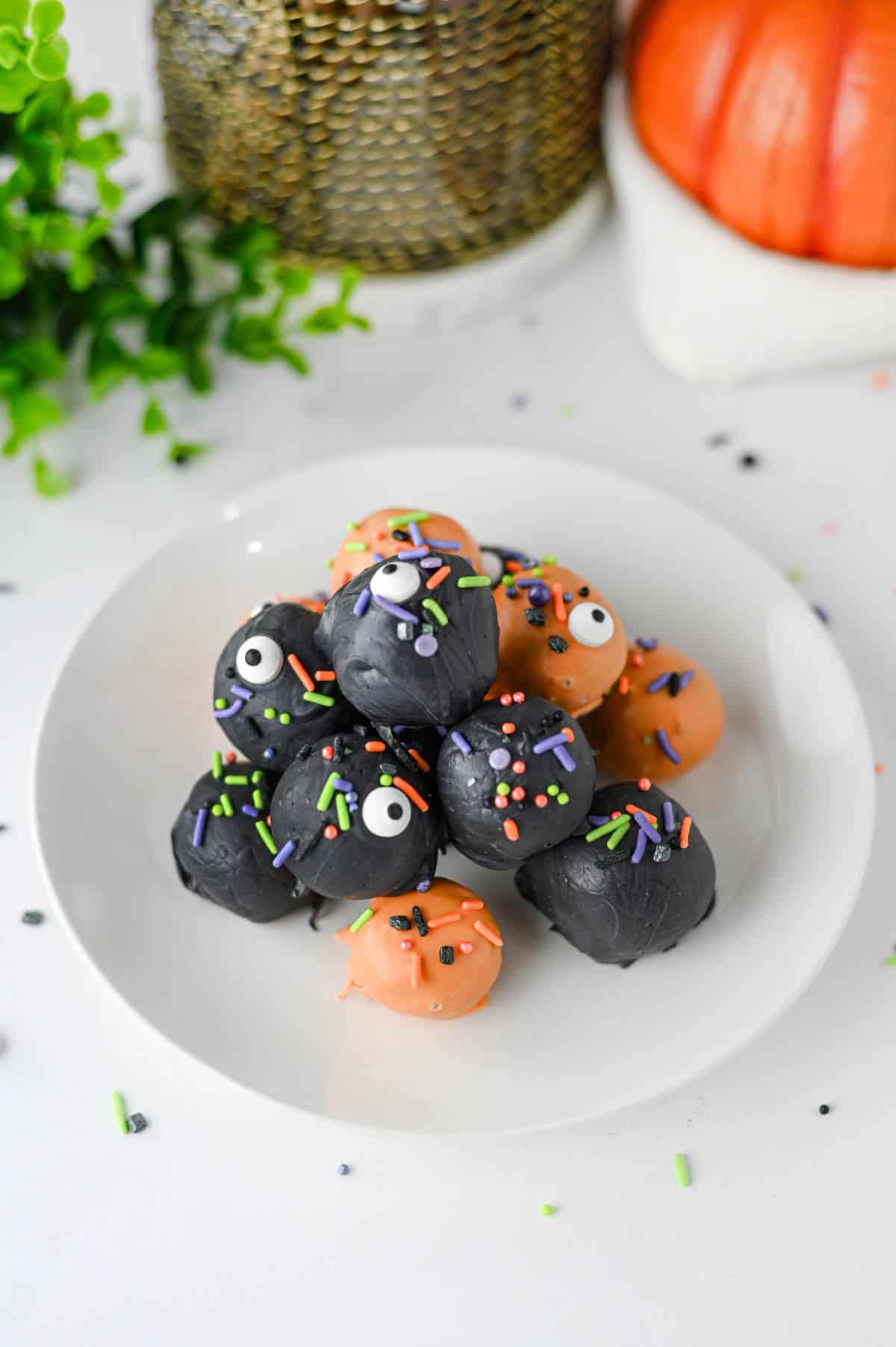 These Halloween Oreo Balls are the ultimate easy no bake Halloween treats for parties and spooky dessert tables! Made with crushed Oreo cookies and cream cheese, these Oreo truffles are dipped in orange and black candy melts and finished with festive Halloween sprinkles. If you're looking for Halloween Oreo balls, Halloween Oreo truffles, easy Halloween desserts, Halloween party food, or fun Halloween treats for kids, this simple recipe is a must-try. They're perfect for Halloween parties, bake sales, potlucks, classroom treats, and movie nights. With just a handful of ingredients and no oven required, these chocolate Oreo balls are an easy Halloween candy treat you can make ahead. Save this Halloween Oreo balls recipe for a spooky and delicious Halloween dessert everyone will love!