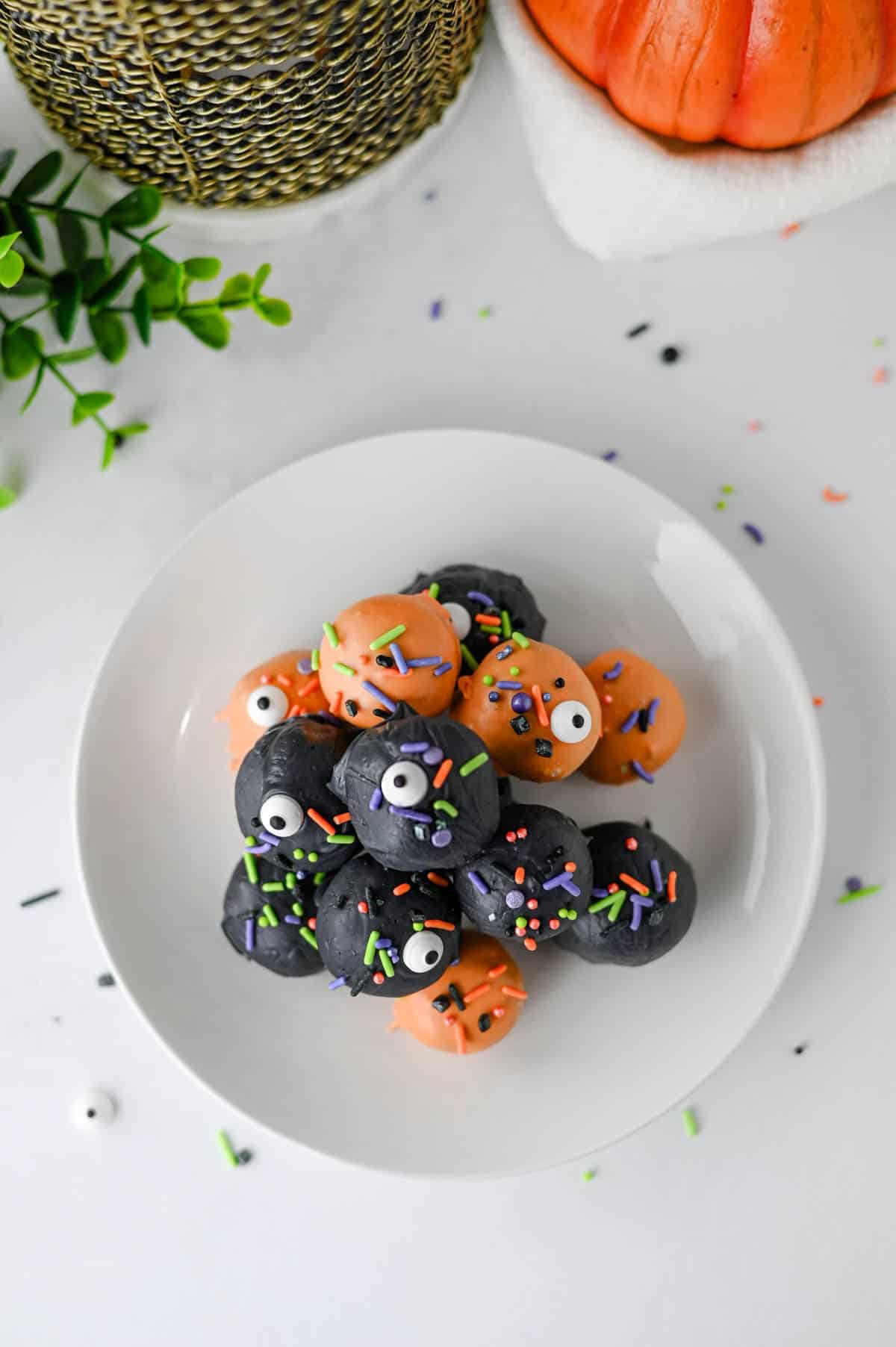 These Halloween Oreo Balls are the ultimate easy no bake Halloween treats for parties and spooky dessert tables! Made with crushed Oreo cookies and cream cheese, these Oreo truffles are dipped in orange and black candy melts and finished with festive Halloween sprinkles. If you're looking for Halloween Oreo balls, Halloween Oreo truffles, easy Halloween desserts, Halloween party food, or fun Halloween treats for kids, this simple recipe is a must-try. They're perfect for Halloween parties, bake sales, potlucks, classroom treats, and movie nights. With just a handful of ingredients and no oven required, these chocolate Oreo balls are an easy Halloween candy treat you can make ahead. Save this Halloween Oreo balls recipe for a spooky and delicious Halloween dessert everyone will love!