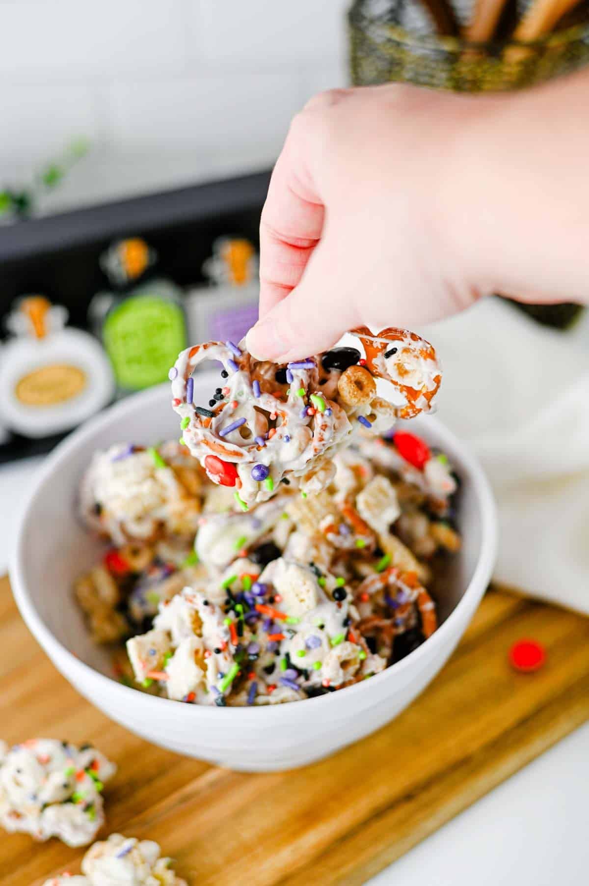 This easy Halloween Snack Mix is the ultimate sweet and salty treat for the spooky season! Made with Rice Chex cereal, Honey Nut Cheerios, pretzels, white chocolate, Halloween M&Ms, and colorful sprinkles, it's perfect for parties, movie nights, and trick-or-treating. If you need Halloween Snack Ideas, Halloween Party Food, Easy No Bake Halloween Treats, Fun Halloween Food, Halloween Treats For Kids, Halloween Chex Mix, or simple Halloween Desserts, this crunchy snack mix is a must-try. It takes just 15 minutes to prep, requires no baking, and is easy to make ahead. The sweet and salty combination makes every bite irresistible. Save this festive Halloween Party Snack Mix for a colorful, crowd-pleasing Halloween snack that kids and adults will keep grabbing by the handful!