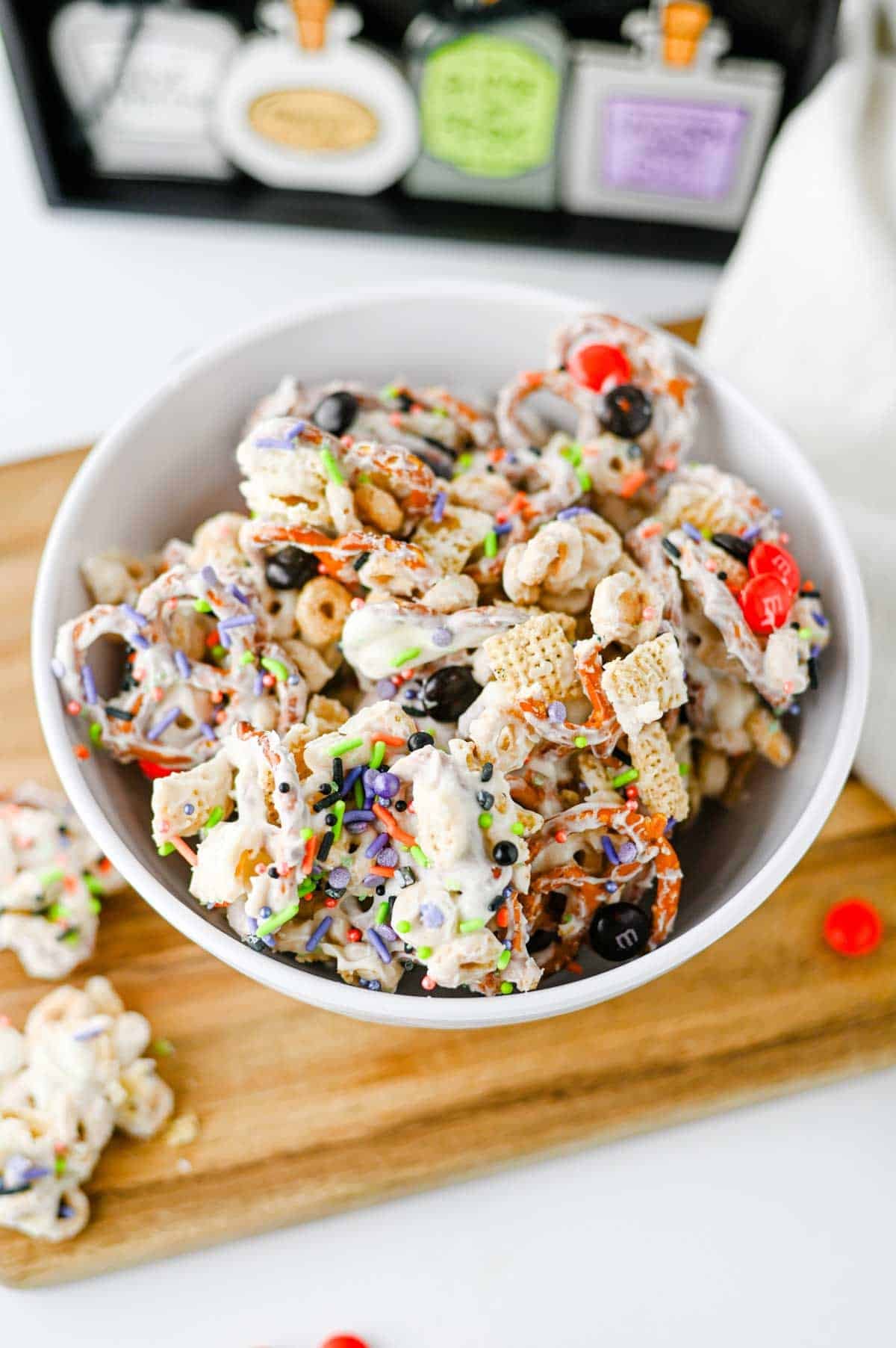 This easy Halloween Snack Mix is the ultimate sweet and salty treat for the spooky season! Made with Rice Chex cereal, Honey Nut Cheerios, pretzels, white chocolate, Halloween M&Ms, and colorful sprinkles, it's perfect for parties, movie nights, and trick-or-treating. If you need Halloween Snack Ideas, Halloween Party Food, Easy No Bake Halloween Treats, Fun Halloween Food, Halloween Treats For Kids, Halloween Chex Mix, or simple Halloween Desserts, this crunchy snack mix is a must-try. It takes just 15 minutes to prep, requires no baking, and is easy to make ahead. The sweet and salty combination makes every bite irresistible. Save this festive Halloween Party Snack Mix for a colorful, crowd-pleasing Halloween snack that kids and adults will keep grabbing by the handful!