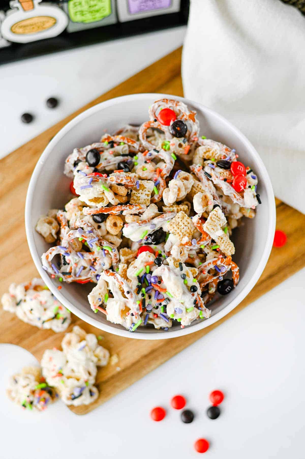 This easy Halloween Snack Mix is the ultimate sweet and salty treat for the spooky season! Made with Rice Chex cereal, Honey Nut Cheerios, pretzels, white chocolate, Halloween M&Ms, and colorful sprinkles, it's perfect for parties, movie nights, and trick-or-treating. If you need Halloween Snack Ideas, Halloween Party Food, Easy No Bake Halloween Treats, Fun Halloween Food, Halloween Treats For Kids, Halloween Chex Mix, or simple Halloween Desserts, this crunchy snack mix is a must-try. It takes just 15 minutes to prep, requires no baking, and is easy to make ahead. The sweet and salty combination makes every bite irresistible. Save this festive Halloween Party Snack Mix for a colorful, crowd-pleasing Halloween snack that kids and adults will keep grabbing by the handful!
