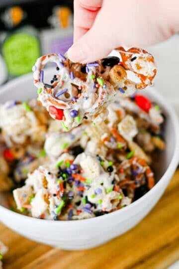This easy Halloween Snack Mix is the ultimate sweet and salty treat for the spooky season! Made with Rice Chex cereal, Honey Nut Cheerios, pretzels, white chocolate, Halloween M&Ms, and colorful sprinkles, it's perfect for parties, movie nights, and trick-or-treating. If you need Halloween Snack Ideas, Halloween Party Food, Easy No Bake Halloween Treats, Fun Halloween Food, Halloween Treats For Kids, Halloween Chex Mix, or simple Halloween Desserts, this crunchy snack mix is a must-try. It takes just 15 minutes to prep, requires no baking, and is easy to make ahead. The sweet and salty combination makes every bite irresistible. Save this festive Halloween Party Snack Mix for a colorful, crowd-pleasing Halloween snack that kids and adults will keep grabbing by the handful!
