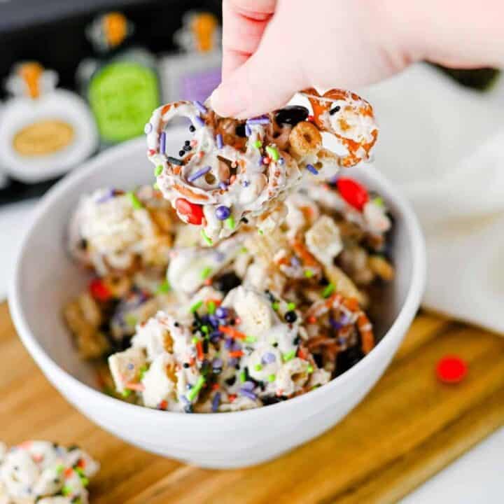 This easy Halloween Snack Mix is the ultimate sweet and salty treat for the spooky season! Made with Rice Chex cereal, Honey Nut Cheerios, pretzels, white chocolate, Halloween M&Ms, and colorful sprinkles, it's perfect for parties, movie nights, and trick-or-treating. If you need Halloween Snack Ideas, Halloween Party Food, Easy No Bake Halloween Treats, Fun Halloween Food, Halloween Treats For Kids, Halloween Chex Mix, or simple Halloween Desserts, this crunchy snack mix is a must-try. It takes just 15 minutes to prep, requires no baking, and is easy to make ahead. The sweet and salty combination makes every bite irresistible. Save this festive Halloween Party Snack Mix for a colorful, crowd-pleasing Halloween snack that kids and adults will keep grabbing by the handful!