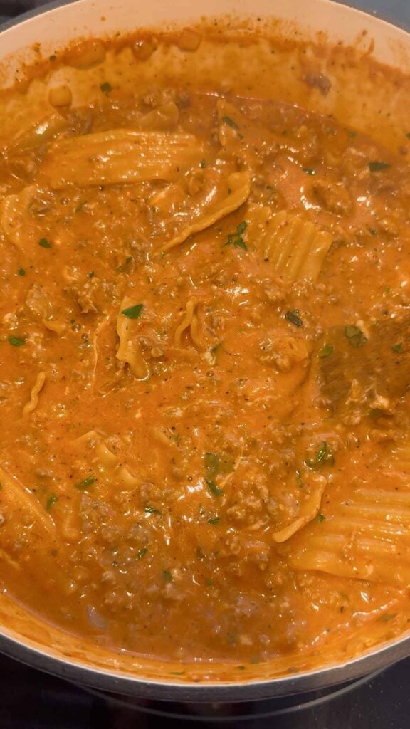 lasagna soup after stirring in chopped basil and mozzarella