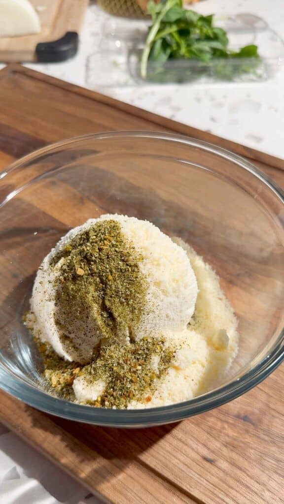 ricotta, parmesan and Italian seasoning in a glass bowl