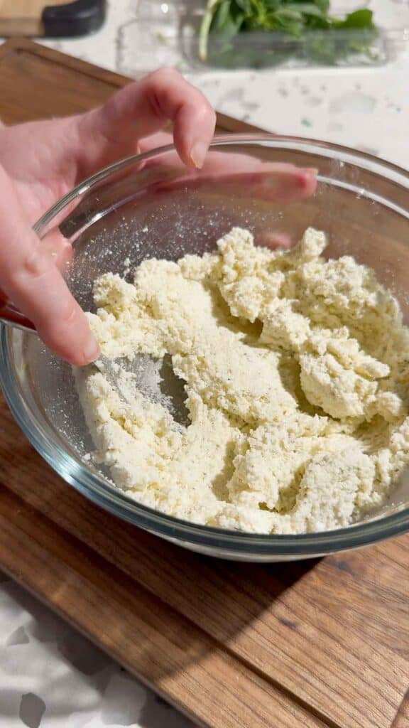 stirring ricotta mixture in a glass bowl
