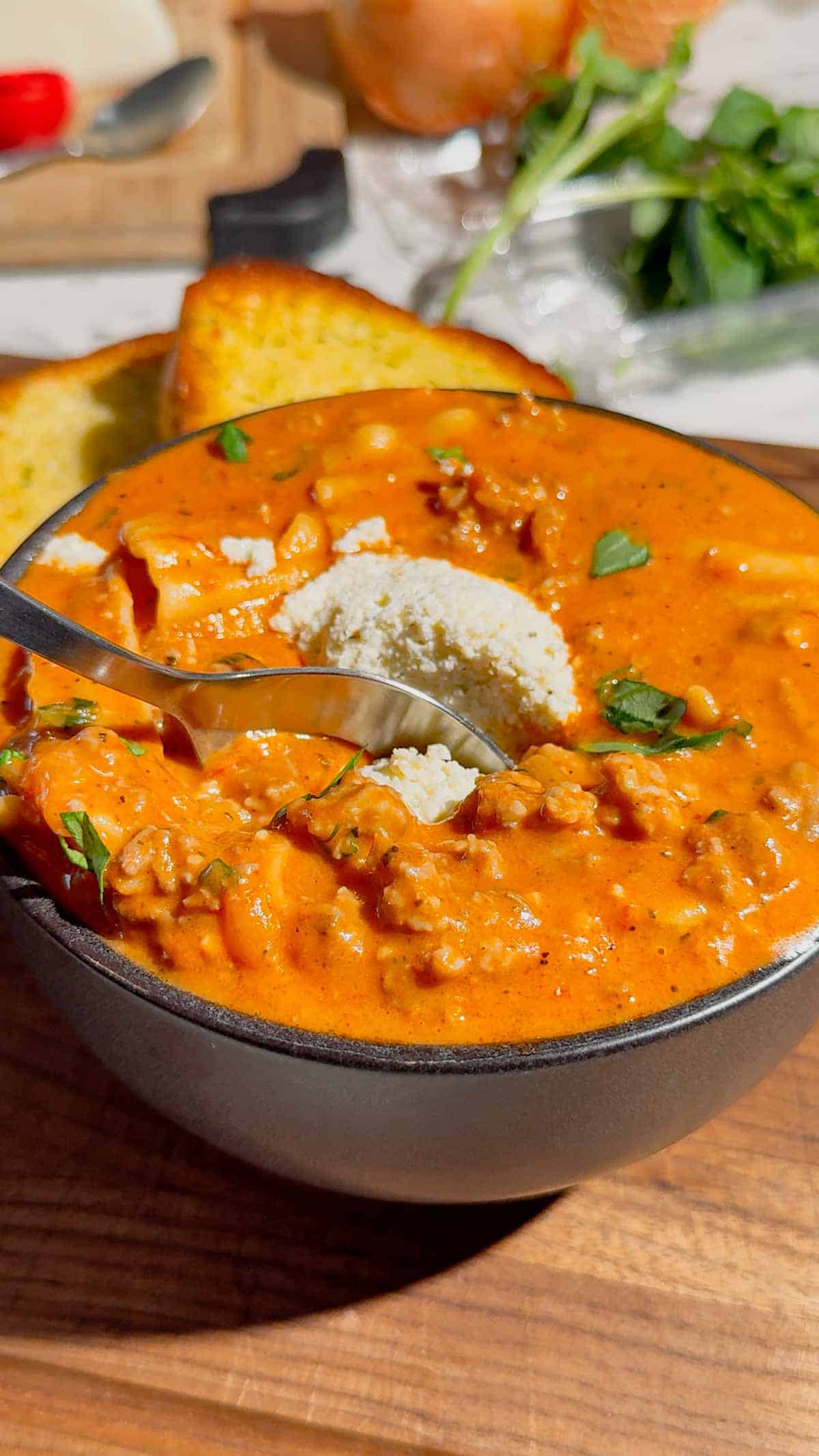This easy Lasagna Soup recipe is the ultimate cozy comfort food for busy weeknights! Made with Italian sausage, ground beef, broken lasagna noodles, pasta sauce, chicken broth, heavy cream, mozzarella, ricotta, Parmesan, and fresh basil, this hearty soup has all the flavors of classic lasagna without the work of layering and baking. If you love easy soup recipes, one pot dinners, Italian soup recipes, or comforting family dinner ideas, this creamy Lasagna Soup is a must-try. It’s an easy 35 minute meal that’s perfect for fall dinners, cold winter nights, or anytime you’re craving cheesy pasta. Save this One Pot Lasagna Soup for an easy weeknight dinner, cozy Sunday supper, or simple family meal everyone will love. The creamy ricotta topping makes every bowl extra delicious!