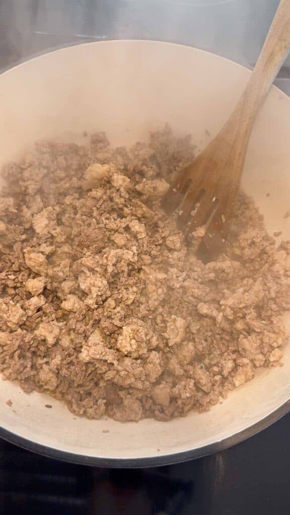 cooked ground beef and sausage in a large pot