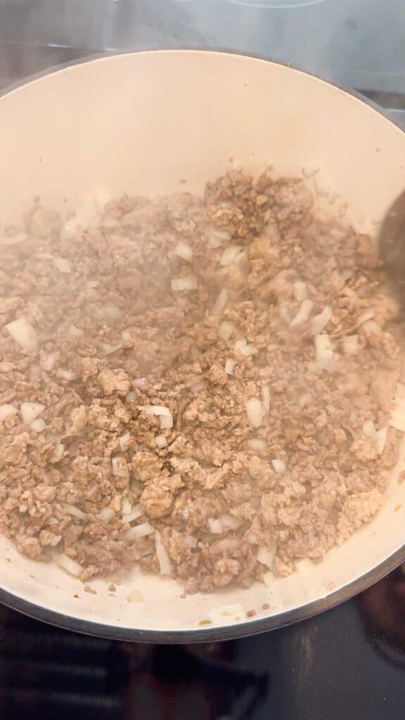 cooked ground meat and diced onions in a large pot