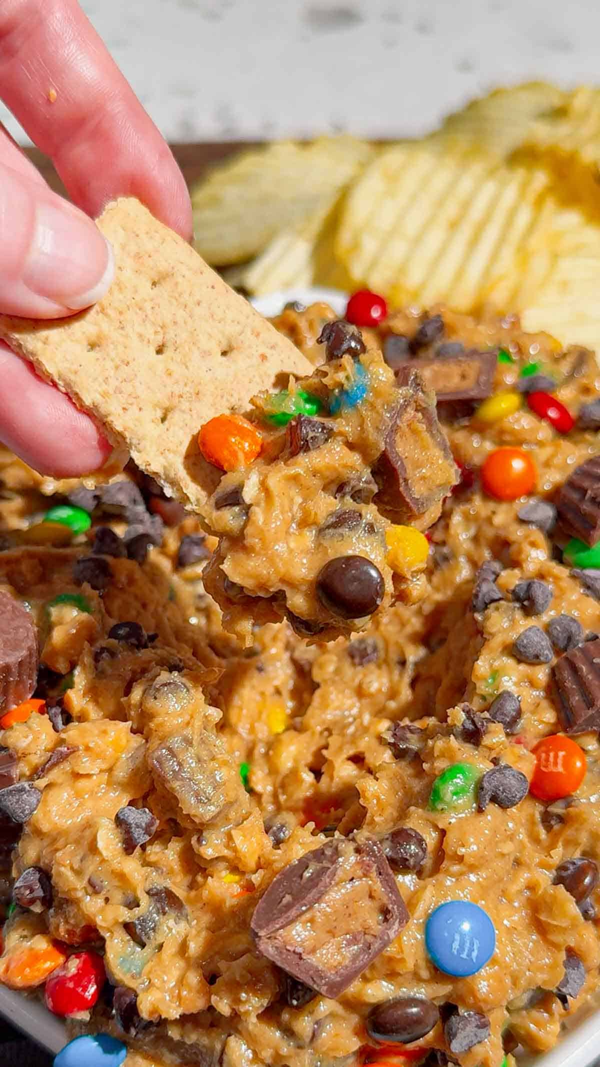 graham cracker dipped in monster cookie dough dip