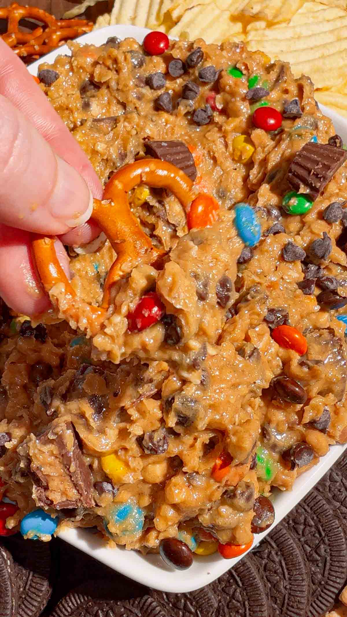 pretzel dipped in monster cookie dough dip
