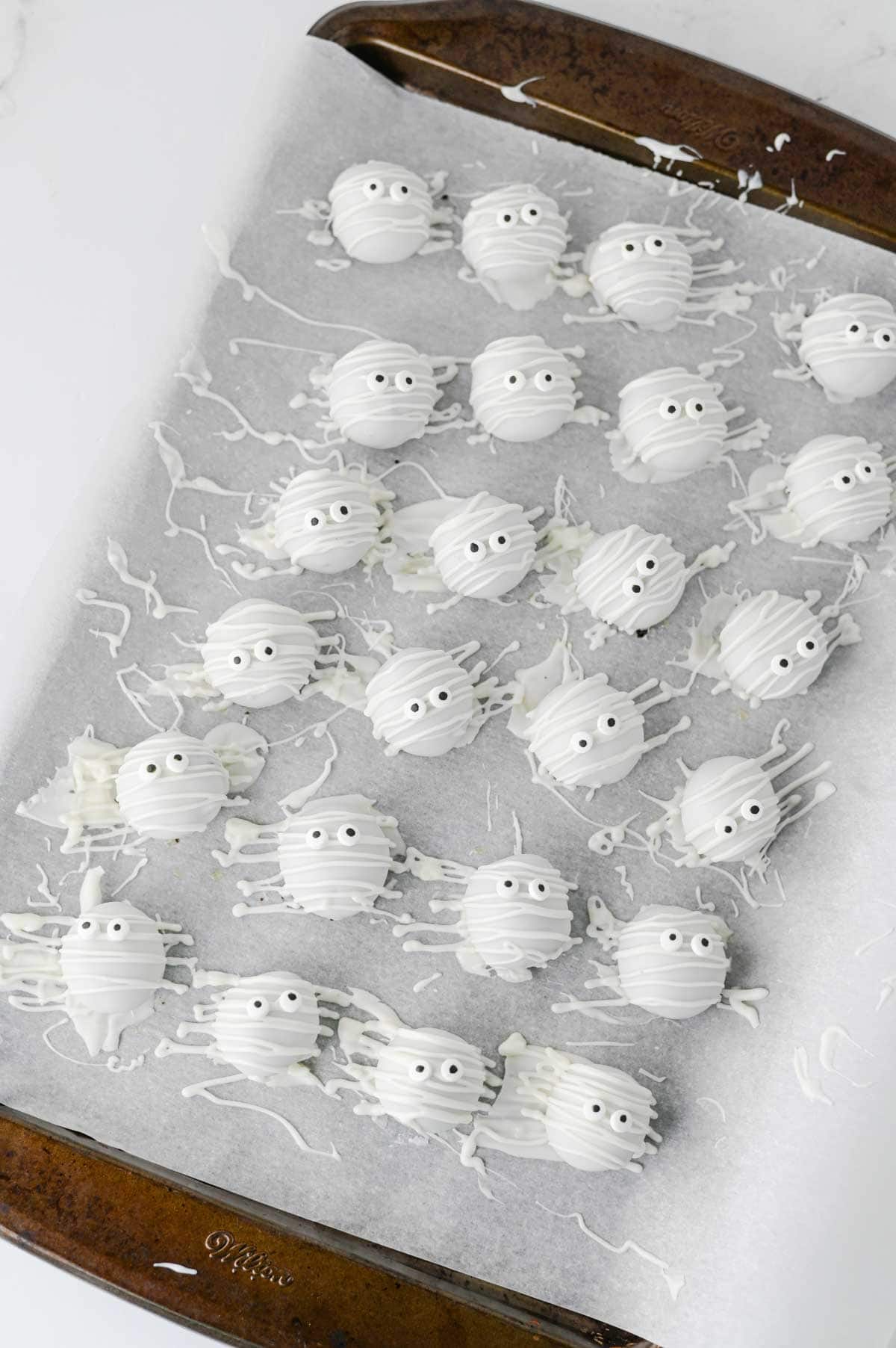 These Mummy Oreo Balls are the ultimate spooky treat for Halloween parties, dessert tables, and school celebrations! Made with crushed Oreo cookies, cream cheese, vanilla almond bark, and candy eyes, this easy Mummy Oreo Balls Recipe is a fun No Bake Halloween Treat that everyone will love. If you're searching for Halloween Oreo Desserts, Mummy Oreo Truffles, Halloween Oreo Balls, Easy Halloween Treats For Kids, or Halloween Dessert Ideas Easy enough for busy days, these cute bites are perfect. The white chocolate mummy wrapping and silly candy eyes make them an adorable Halloween Party Food idea. Add these Oreo Mummy Balls to your list of Halloween Desserts No Bake, Spooky Treats, Halloween Goodies, and Easy Halloween Desserts For Parties for a sweet treat everyone will grab!