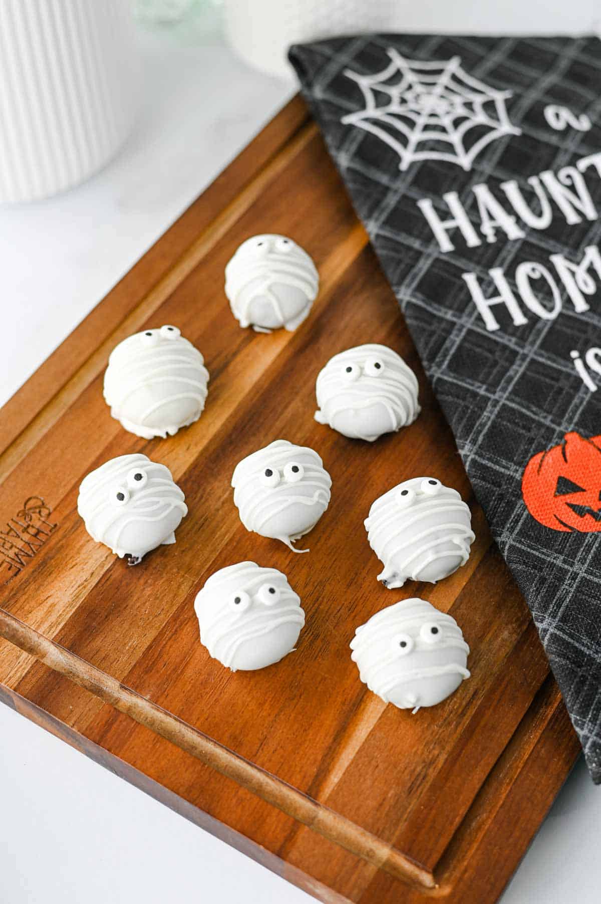 These Mummy Oreo Balls are the ultimate spooky treat for Halloween parties, dessert tables, and school celebrations! Made with crushed Oreo cookies, cream cheese, vanilla almond bark, and candy eyes, this easy Mummy Oreo Balls Recipe is a fun No Bake Halloween Treat that everyone will love. If you're searching for Halloween Oreo Desserts, Mummy Oreo Truffles, Halloween Oreo Balls, Easy Halloween Treats For Kids, or Halloween Dessert Ideas Easy enough for busy days, these cute bites are perfect. The white chocolate mummy wrapping and silly candy eyes make them an adorable Halloween Party Food idea. Add these Oreo Mummy Balls to your list of Halloween Desserts No Bake, Spooky Treats, Halloween Goodies, and Easy Halloween Desserts For Parties for a sweet treat everyone will grab!