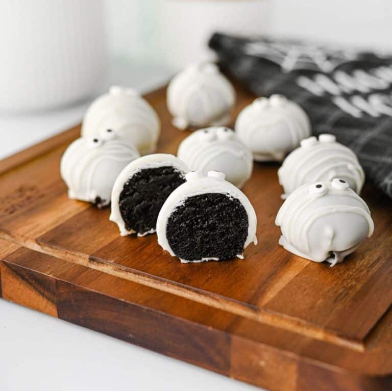 These Mummy Oreo Balls are the ultimate spooky treat for Halloween parties, dessert tables, and school celebrations! Made with crushed Oreo cookies, cream cheese, vanilla almond bark, and candy eyes, this easy Mummy Oreo Balls Recipe is a fun No Bake Halloween Treat that everyone will love. If you're searching for Halloween Oreo Desserts, Mummy Oreo Truffles, Halloween Oreo Balls, Easy Halloween Treats For Kids, or Halloween Dessert Ideas Easy enough for busy days, these cute bites are perfect. The white chocolate mummy wrapping and silly candy eyes make them an adorable Halloween Party Food idea. Add these Oreo Mummy Balls to your list of Halloween Desserts No Bake, Spooky Treats, Halloween Goodies, and Easy Halloween Desserts For Parties for a sweet treat everyone will grab!