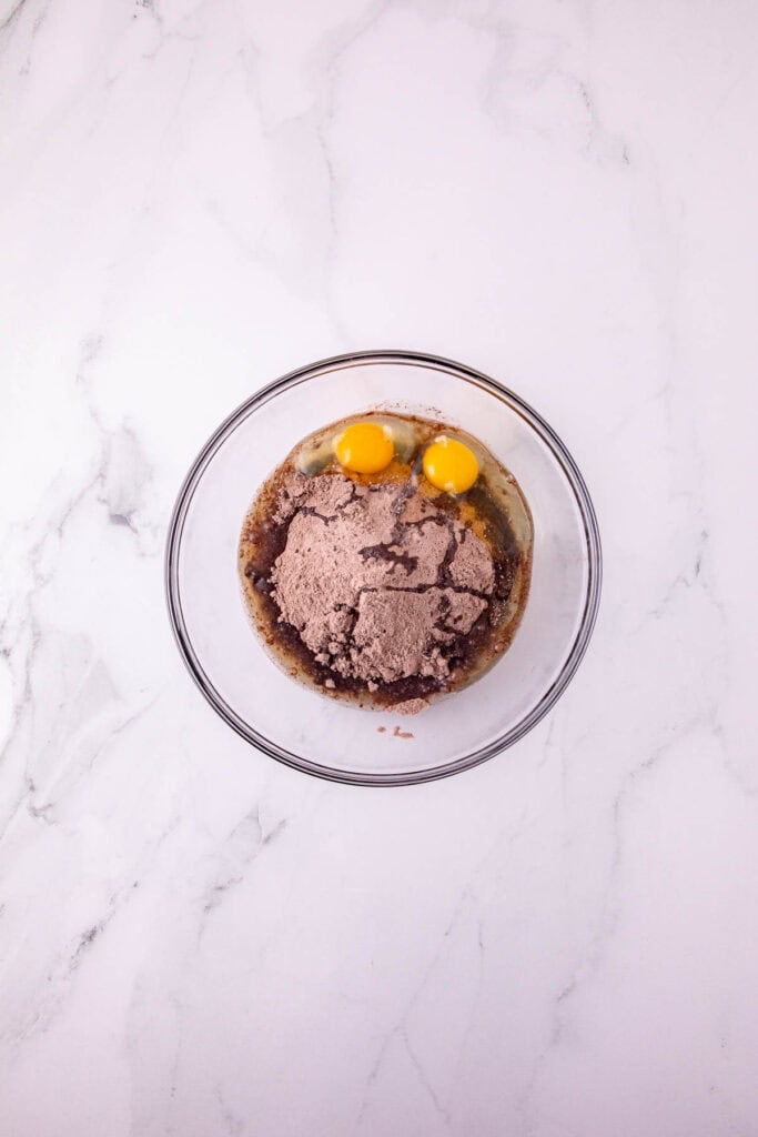 eggs and chocolate cake mix in a mixing bowl