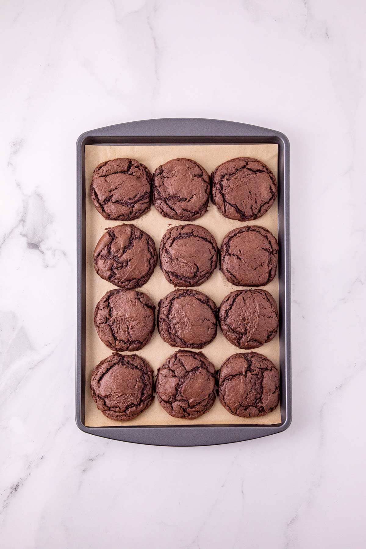 chocolate cookies on a parchment lined baking sheet