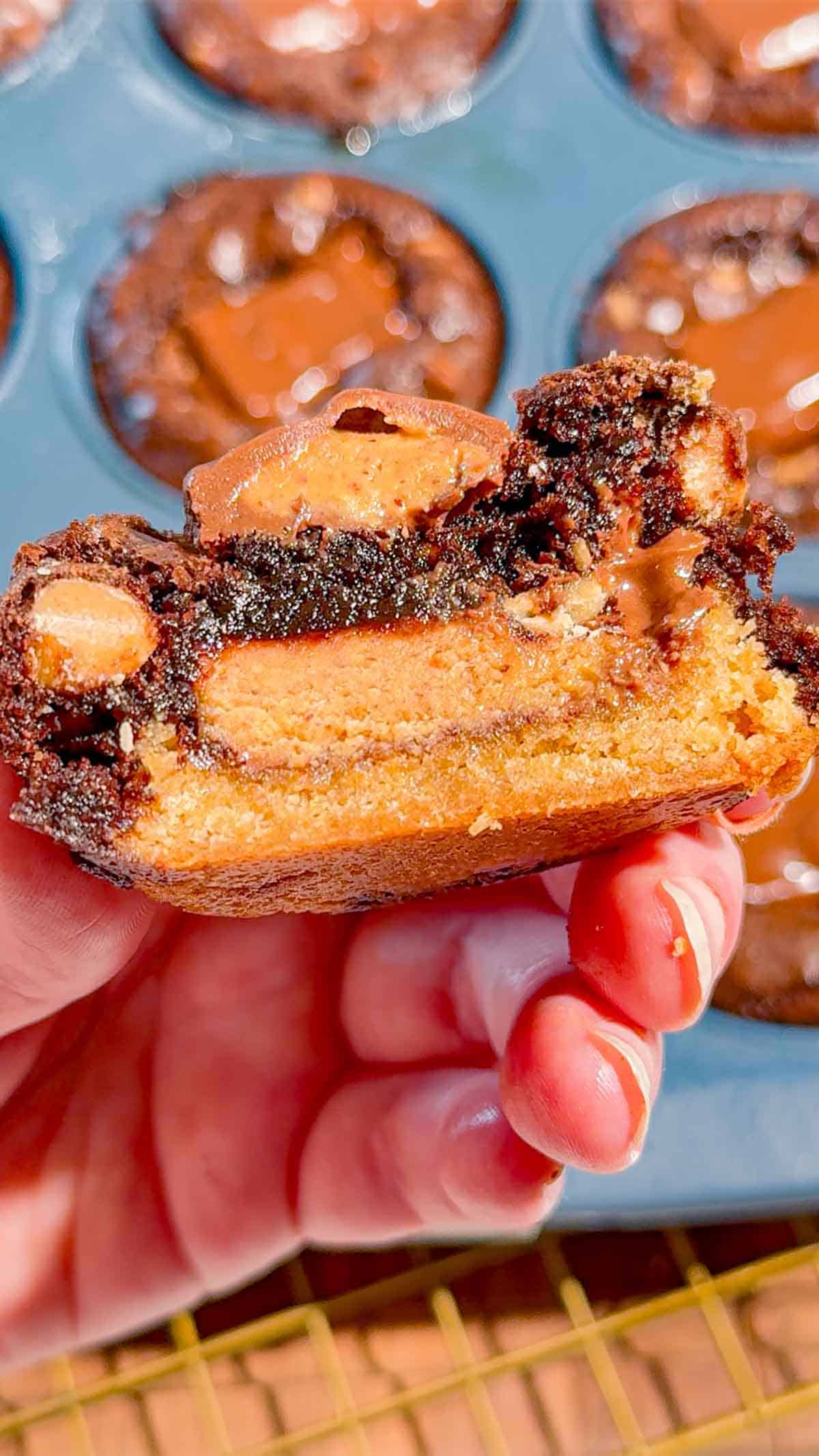 Reese's Stuffed Peanut Butter Brookies are the ultimate dessert for chocolate and peanut butter lovers! These easy muffin tin brookies start with Pillsbury peanut butter cookie dough, then get loaded with Reese's Peanut Butter Cups, Reese's brownie batter and pieces of Reese's peanut butter bar. Ready in just 33 minutes, this easy brookie recipe is perfect for parties, potlucks, holidays or whenever you need an indulgent treat. Save this recipe if you love Reese's desserts, peanut butter cup recipes, brownie cookie desserts, stuffed brookies, easy brownie mix recipes and muffin tin desserts. Every bite has a chewy peanut butter cookie base, a gooey candy center and a fudgy brownie top. These brownie cups are easy to serve and packed with chocolate peanut butter flavor!