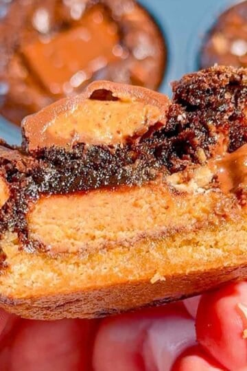 Reese's Stuffed Peanut Butter Brookies are the ultimate dessert for chocolate and peanut butter lovers! These easy muffin tin brookies start with Pillsbury peanut butter cookie dough, then get loaded with Reese's Peanut Butter Cups, Reese's brownie batter and pieces of Reese's peanut butter bar. Ready in just 33 minutes, this easy brookie recipe is perfect for parties, potlucks, holidays or whenever you need an indulgent treat. Save this recipe if you love Reese's desserts, peanut butter cup recipes, brownie cookie desserts, stuffed brookies, easy brownie mix recipes and muffin tin desserts. Every bite has a chewy peanut butter cookie base, a gooey candy center and a fudgy brownie top. These brownie cups are easy to serve and packed with chocolate peanut butter flavor!