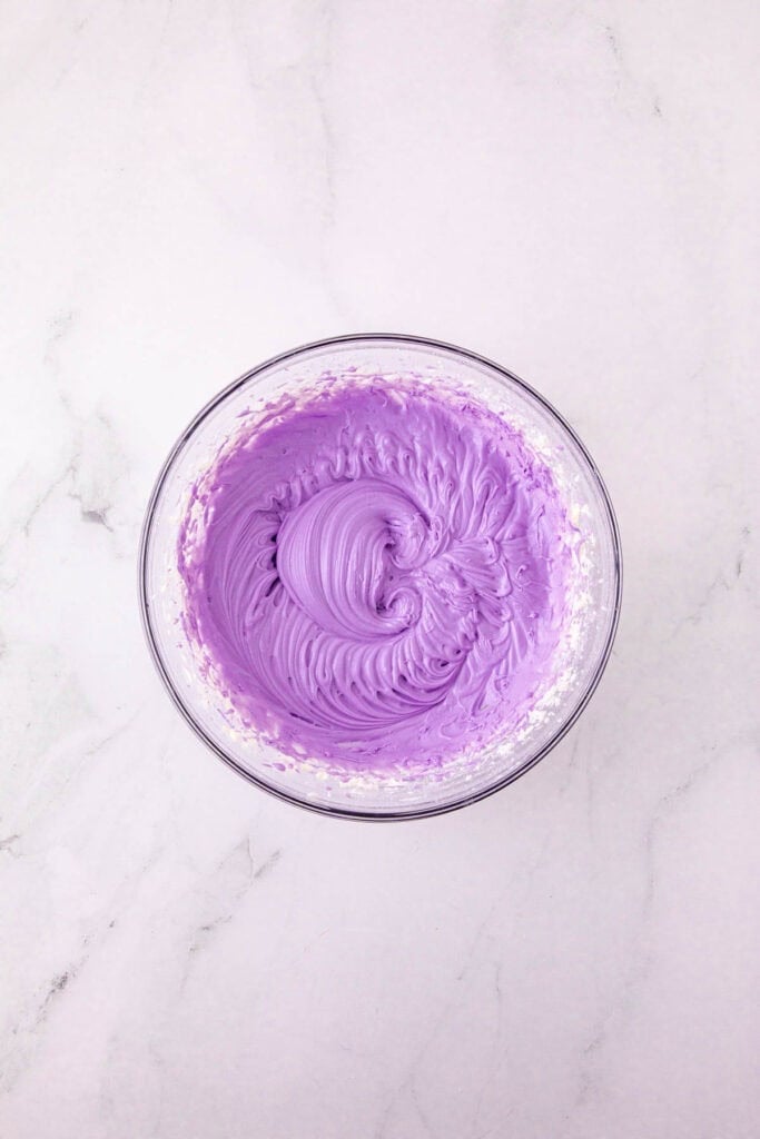 purple frosting in a mixing bowl