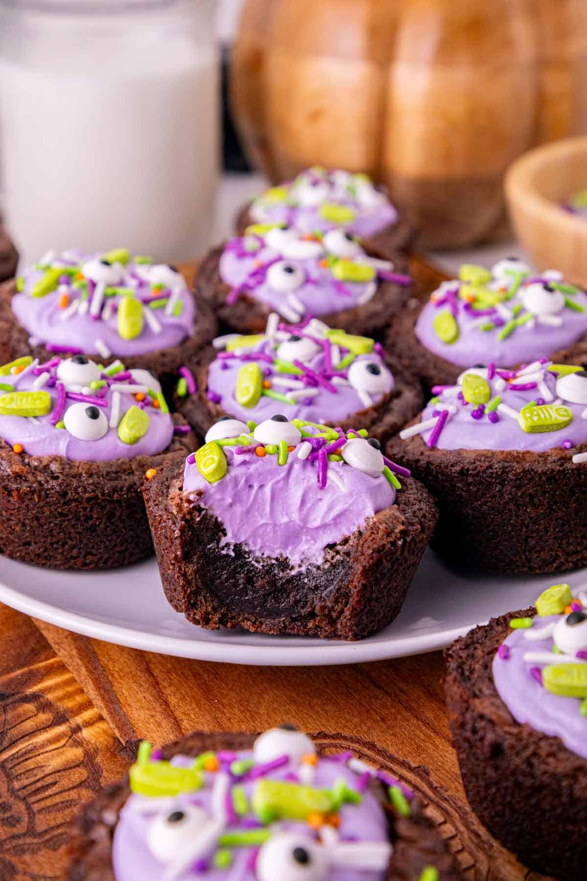 halloween mini brownies with purple frosting and sprinkles