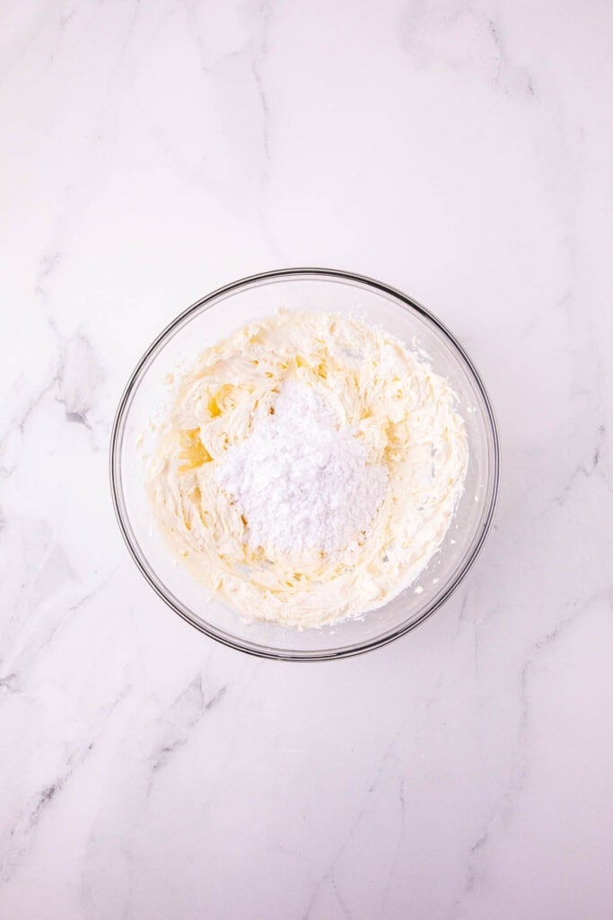 powdered sugar and cream cheese mixture in a mixing bowl