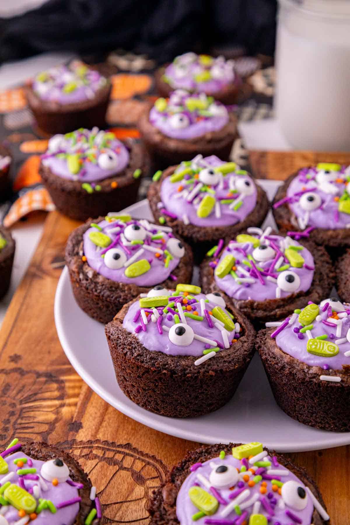 witch cauldron brownies with purple frosting on a plate