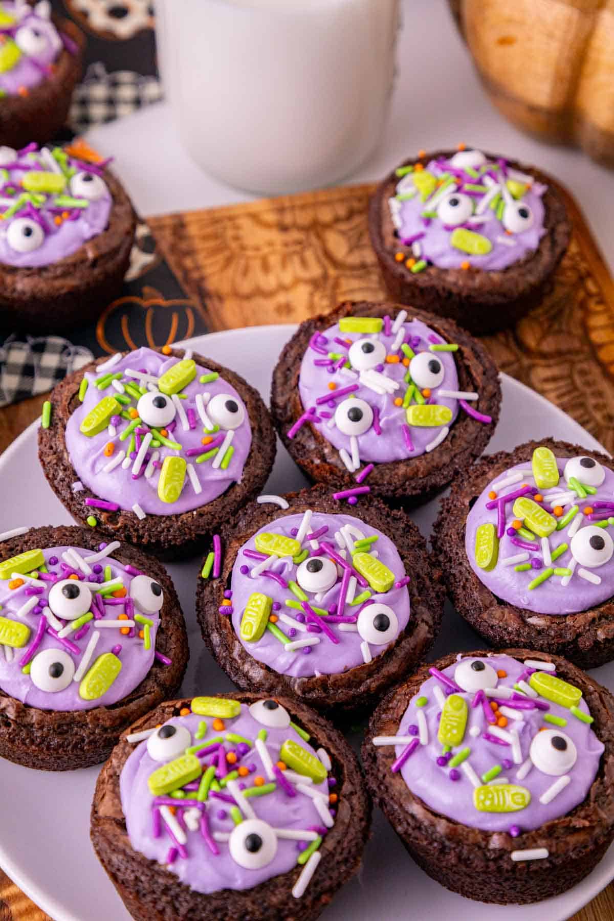 witch cauldron brownies with purple frosting on a plate