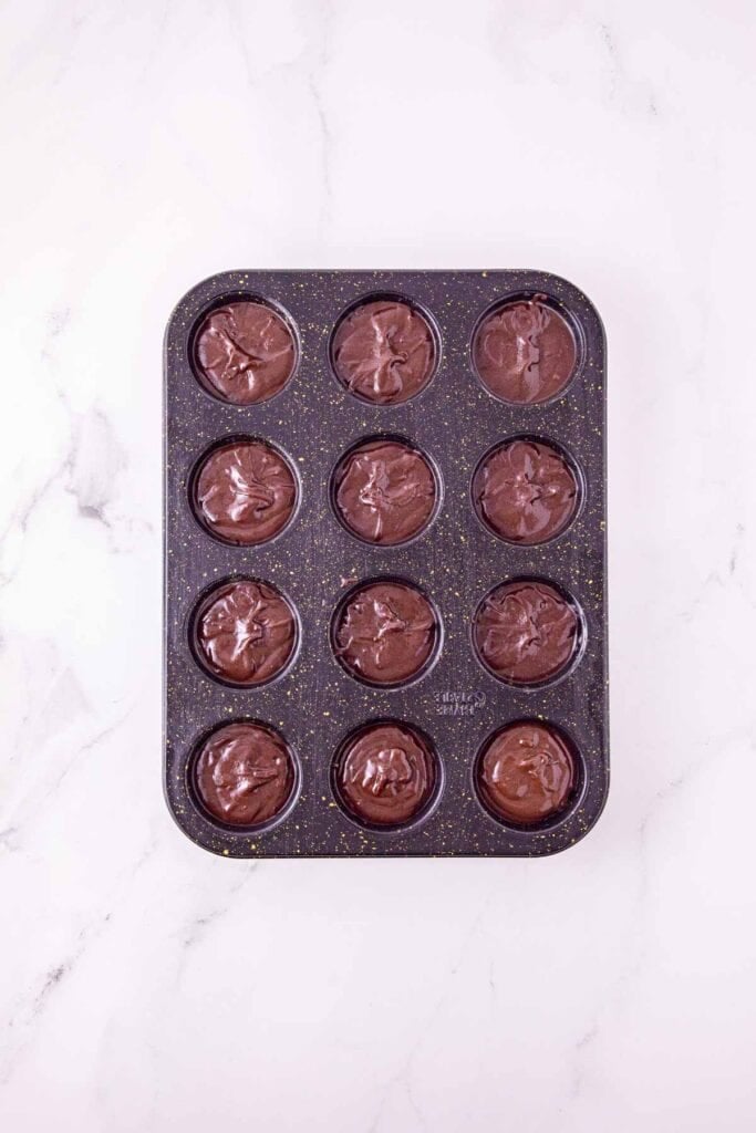 brownie batter in a mini muffin tin