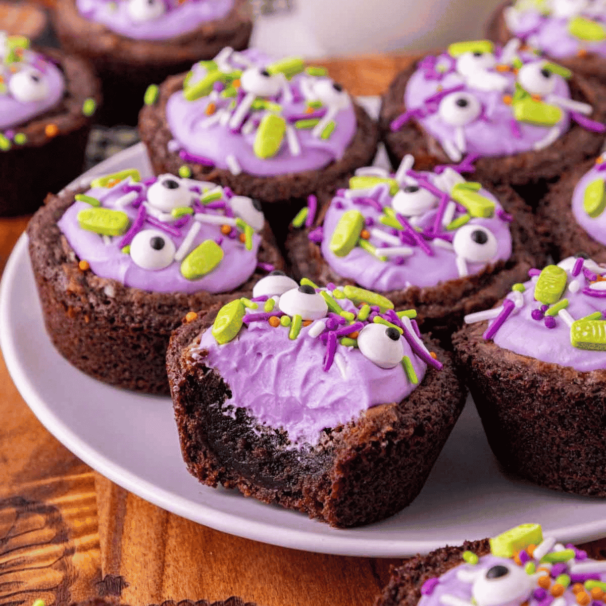 These Witch Cauldron Brownies are a fun and easy Halloween dessert recipe made with boxed fudge brownie mix, cream cheese frosting, purple gel food coloring and spooky Halloween sprinkles. Baked in muffin tins and pressed into little cauldron shapes, these cute Halloween brownies are perfect for Halloween baking ideas, Halloween party food, classroom treats, spooky desserts, Halloween brownie bites and kid friendly Halloween treats. The fudgy brownie cups are filled with colorful frosting and topped with candy eyes, bones or festive sprinkles for a creepy cute treat that looks impressive but starts with simple brownie mix. Add pretzel sticks or Pocky for little stirring spoons and serve these witch cauldron treats at your next Halloween dessert table or movie night.